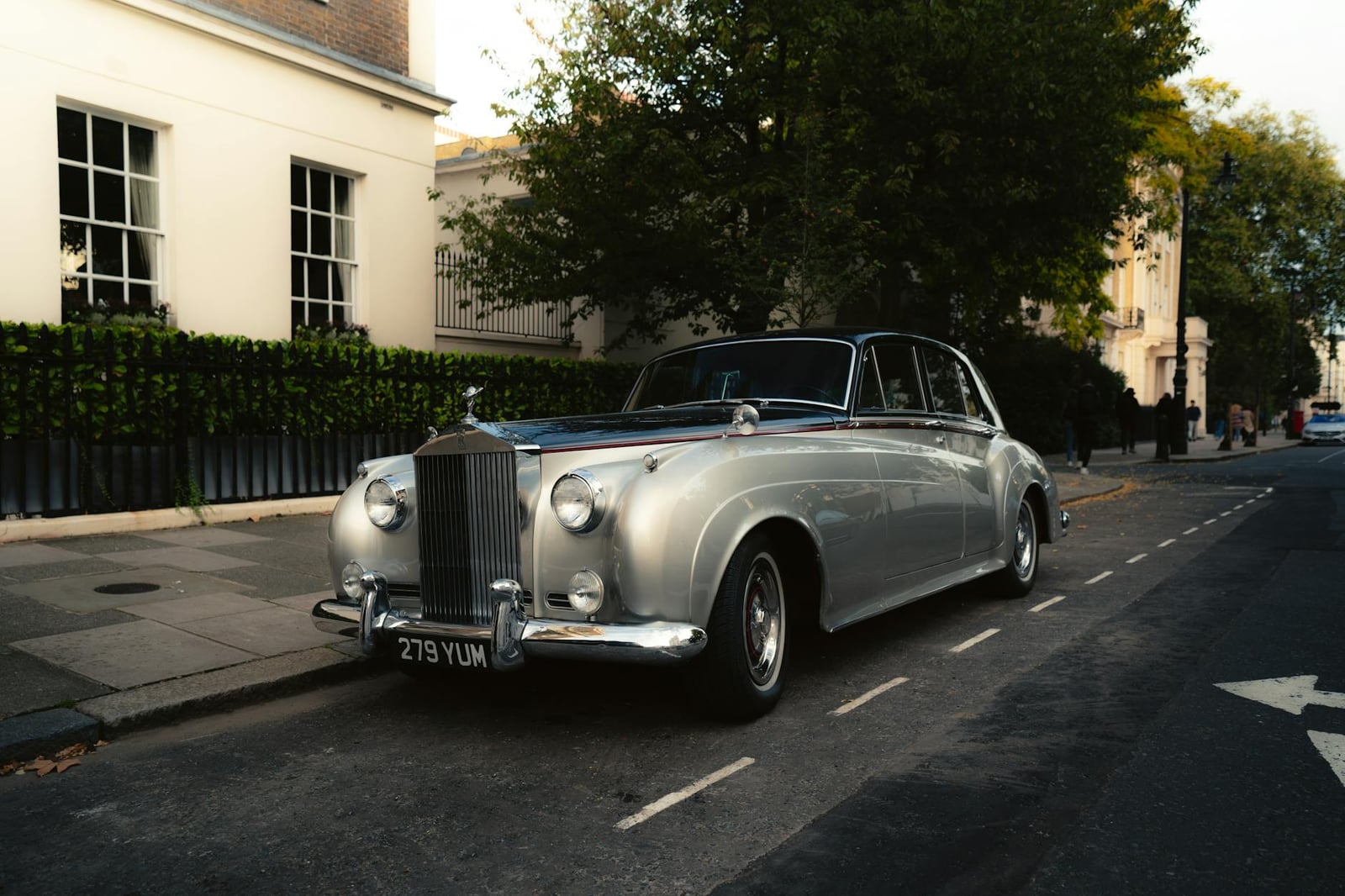 A silver Rolls-Royce saloon parked on a London street