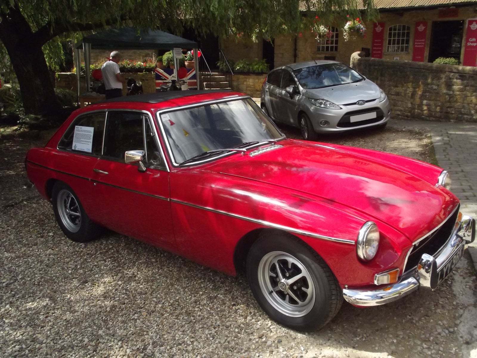 A red MG MGB GT on display at a motoring museum