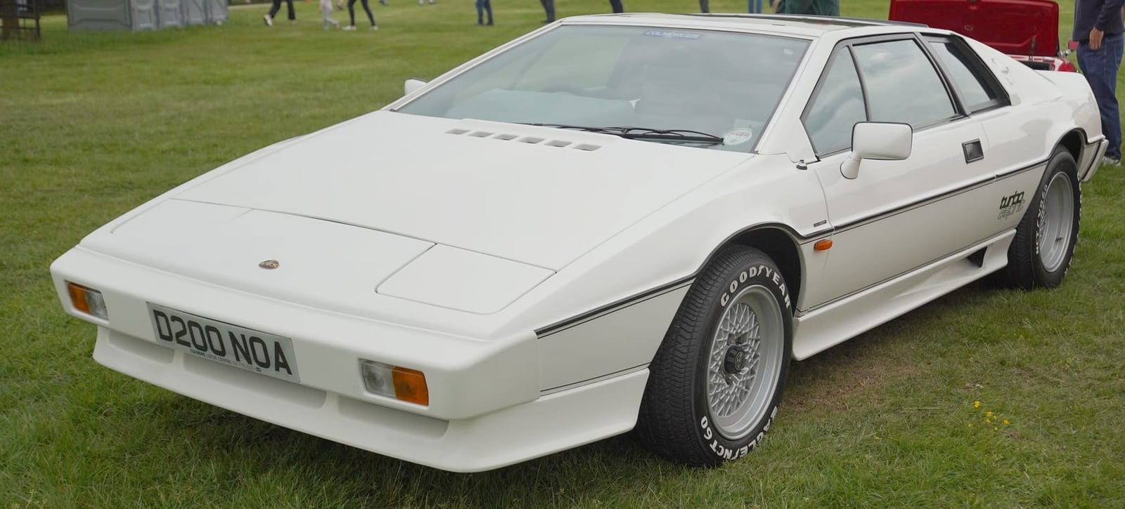 A white Lotus Turbo Esprit with a UK registration on grass at a show