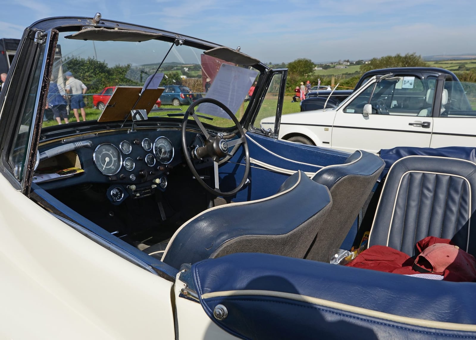 The interior of a Daimler Conquest Roadster showing the dashboard dials, bench seat and preselector controls