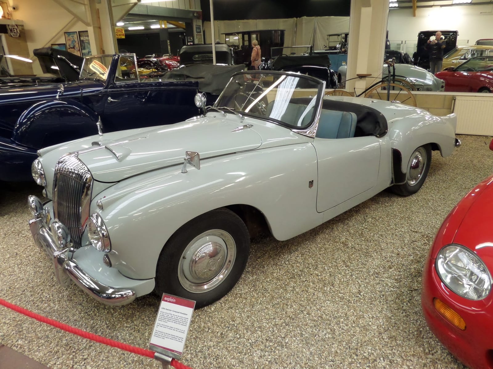 A grey 1954 Daimler Conquest DJ Roadster displayed in a museum