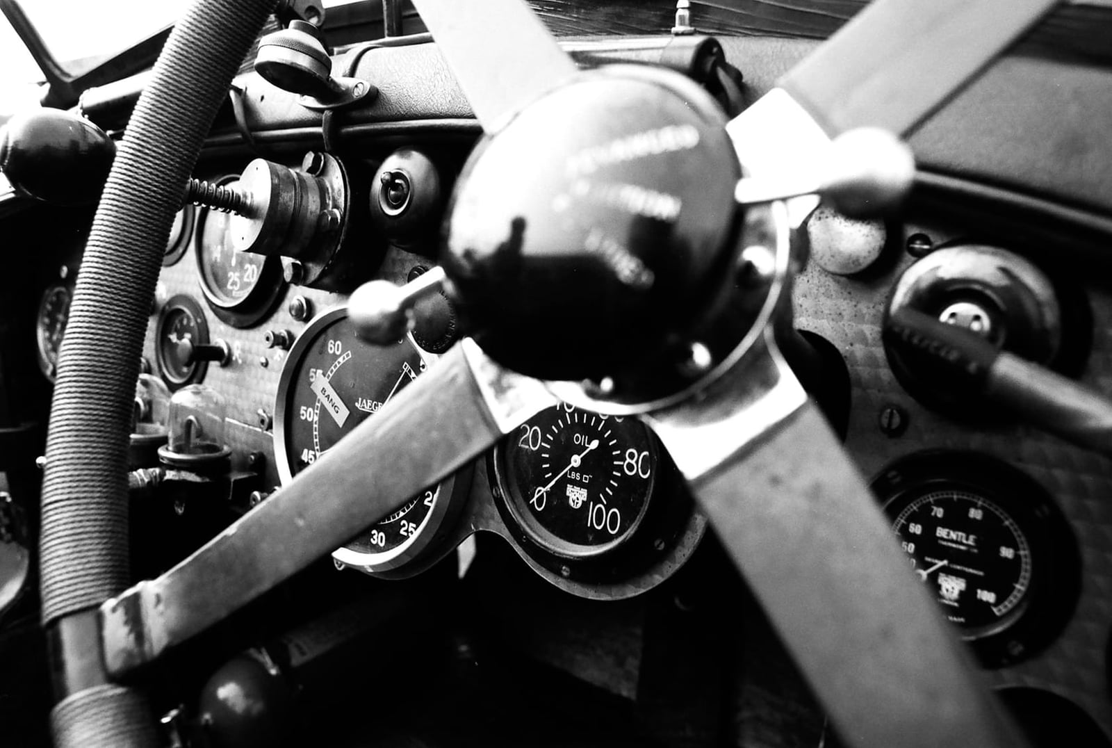 A black and white close view of a Blower Bentley dashboard with large tachometer