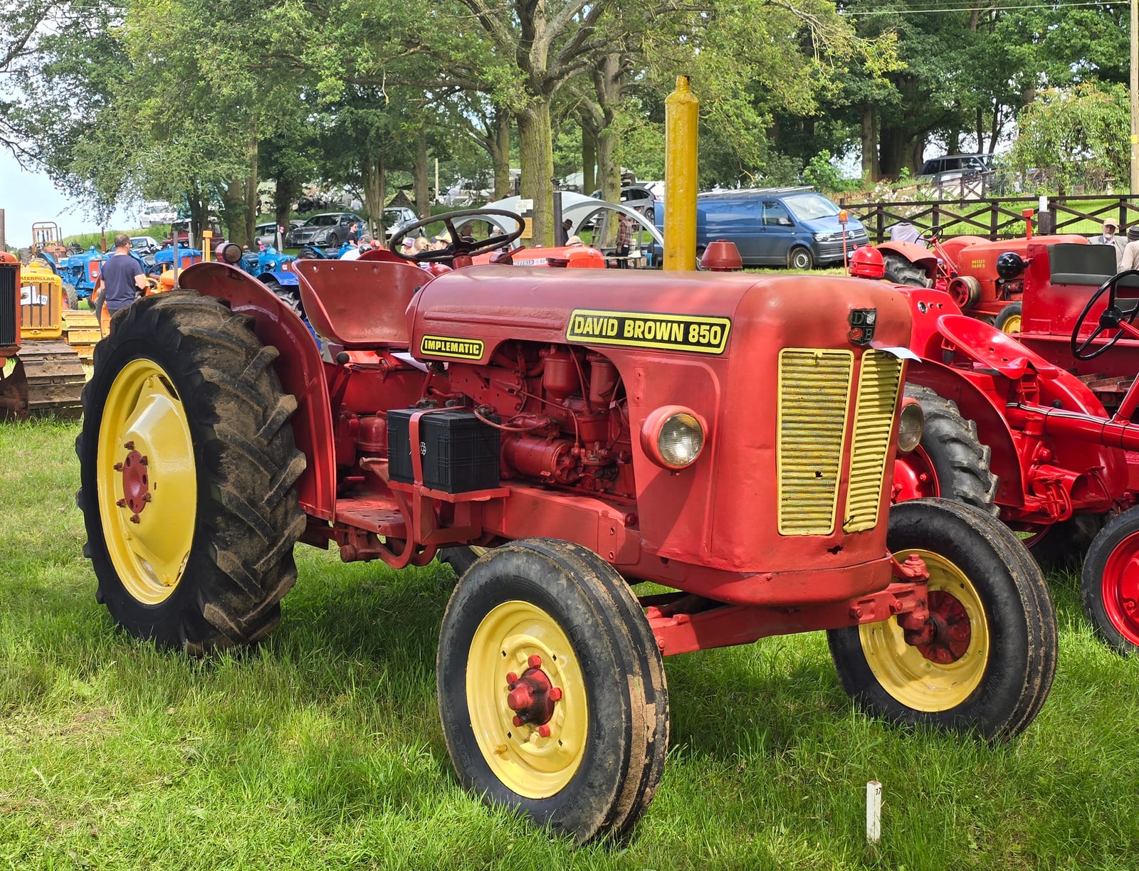 A red and yellow David Brown 850 Implematic on grass at a show