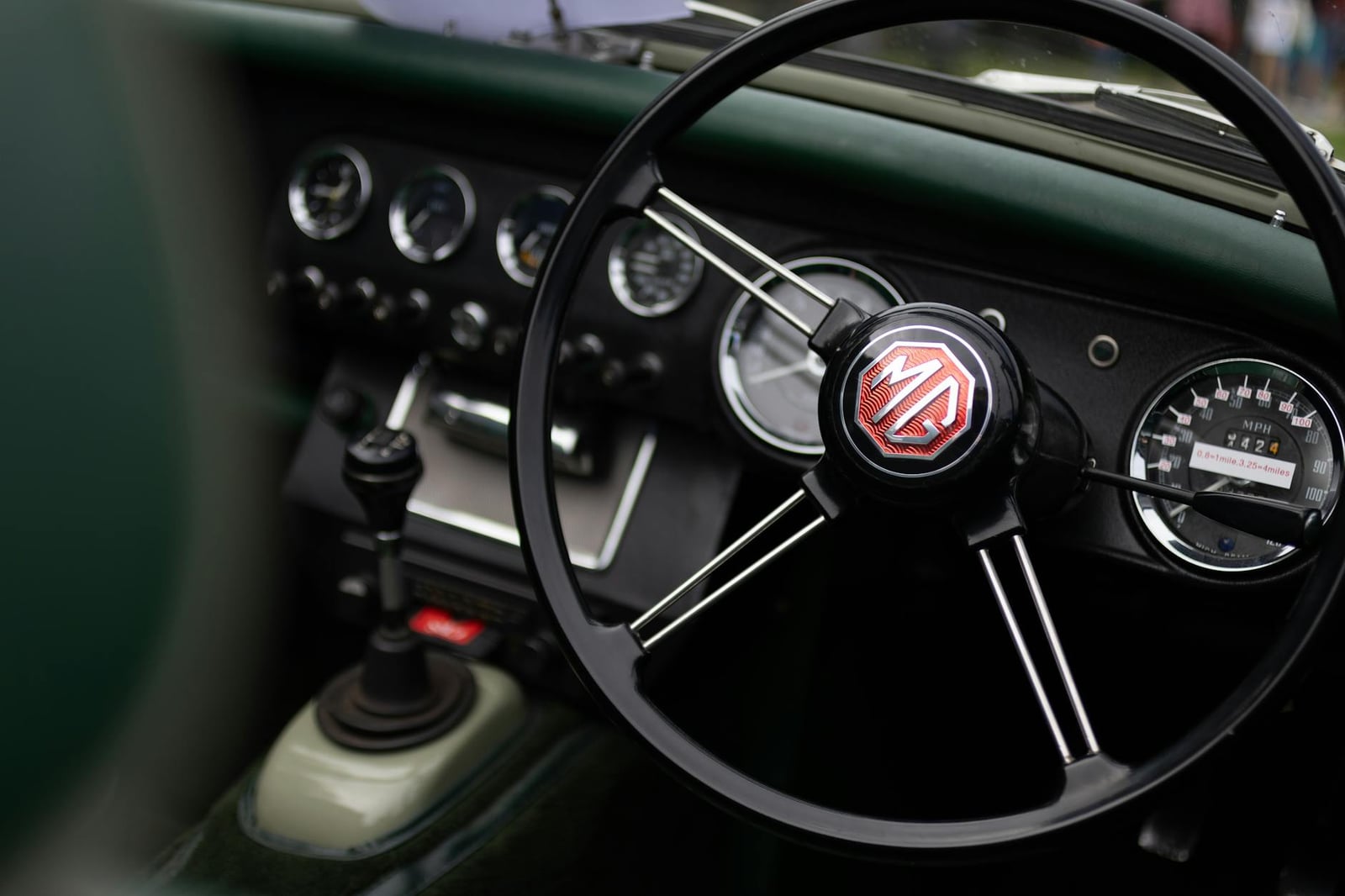 The interior of an MG Midget, showing the dashboard and steering wheel