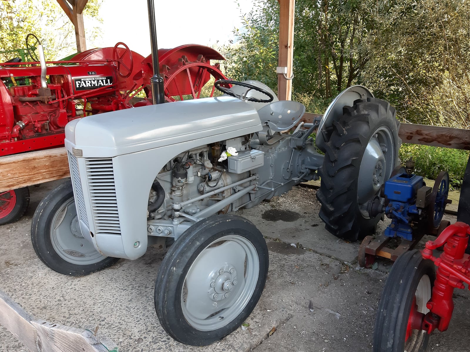 A grey Ferguson TE20 parked beside a farm shed