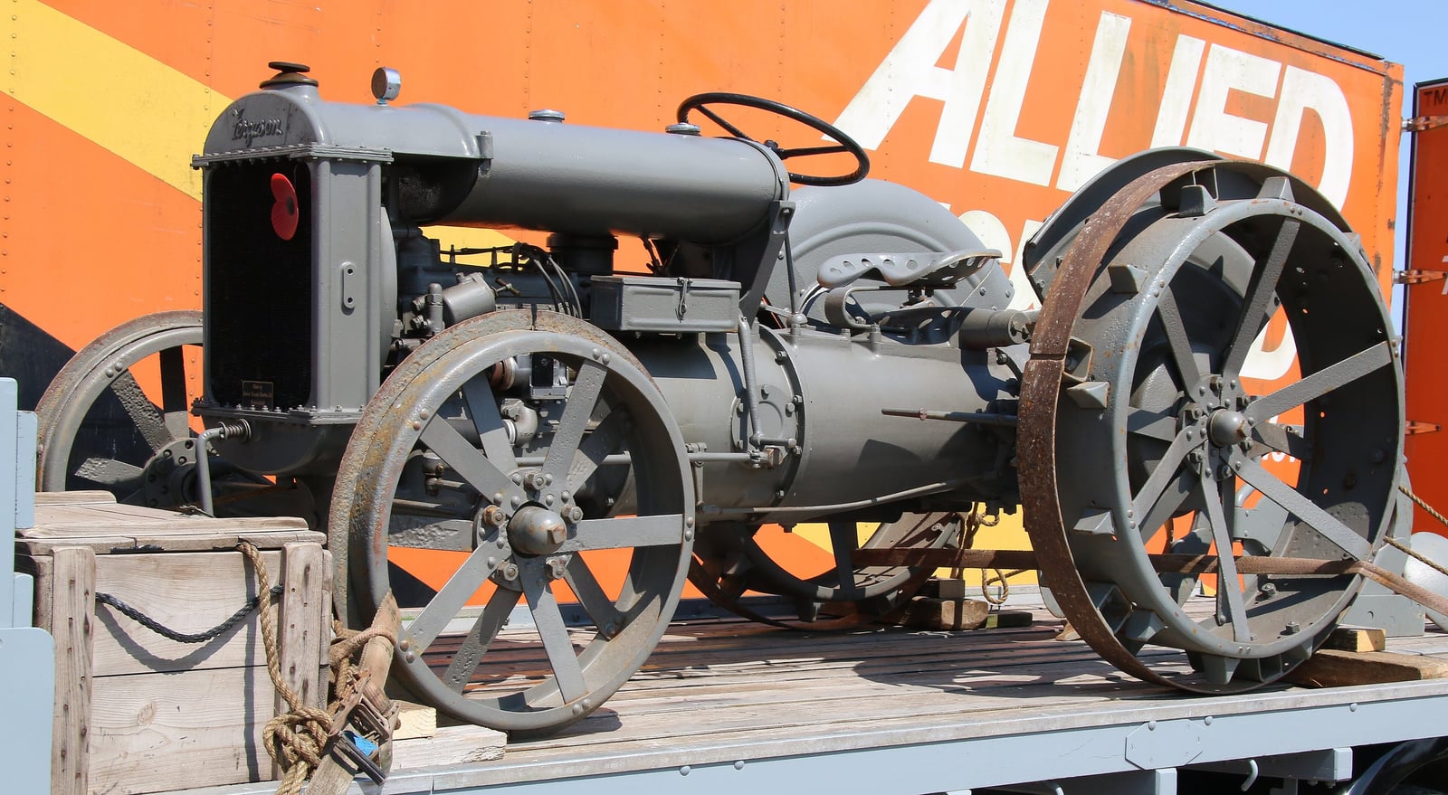An early grey Ferguson-Brown Type A tractor on steel spoked wheels, displayed on a flatbed