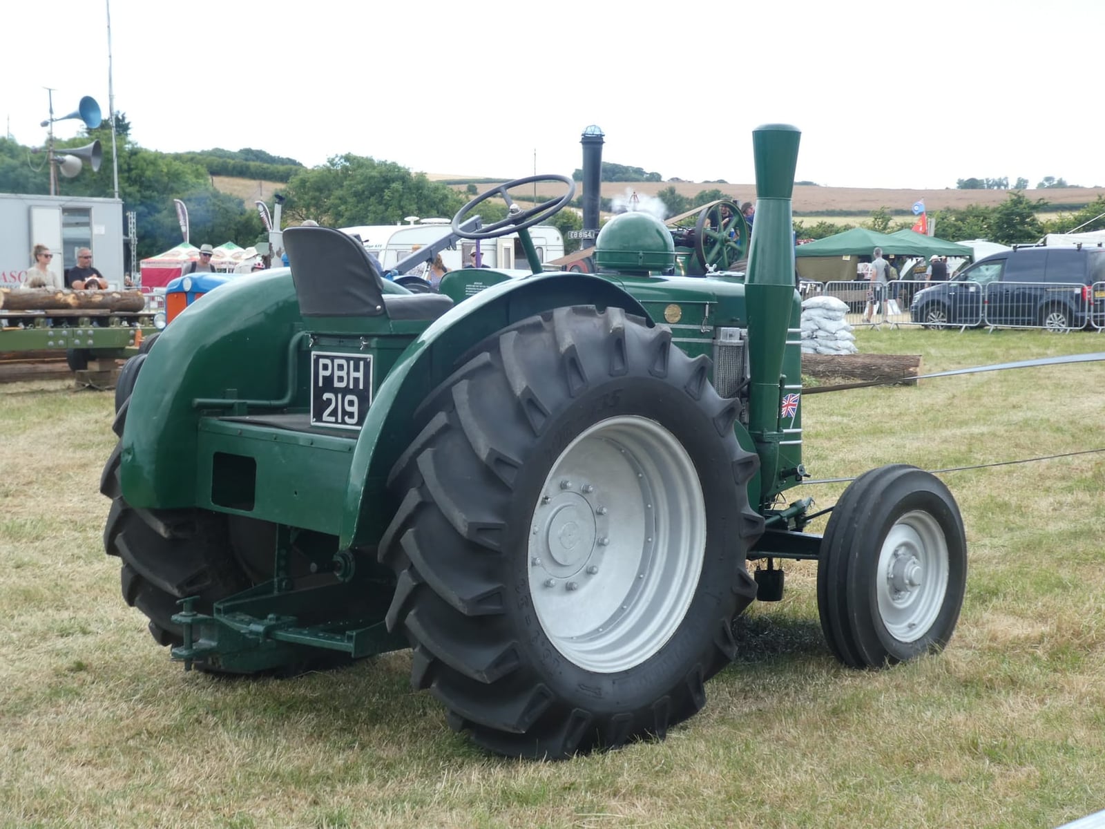 The rear three-quarter of a green 1952 Field Marshall tractor, UK registration PBH 219