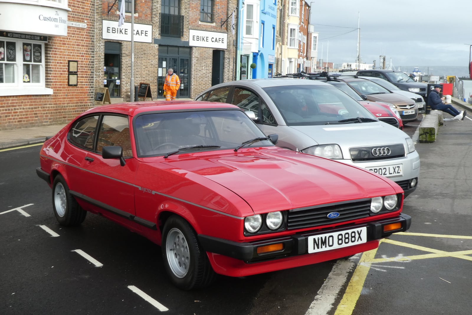 A red Ford Capri 2.8 Injection, front three-quarter view