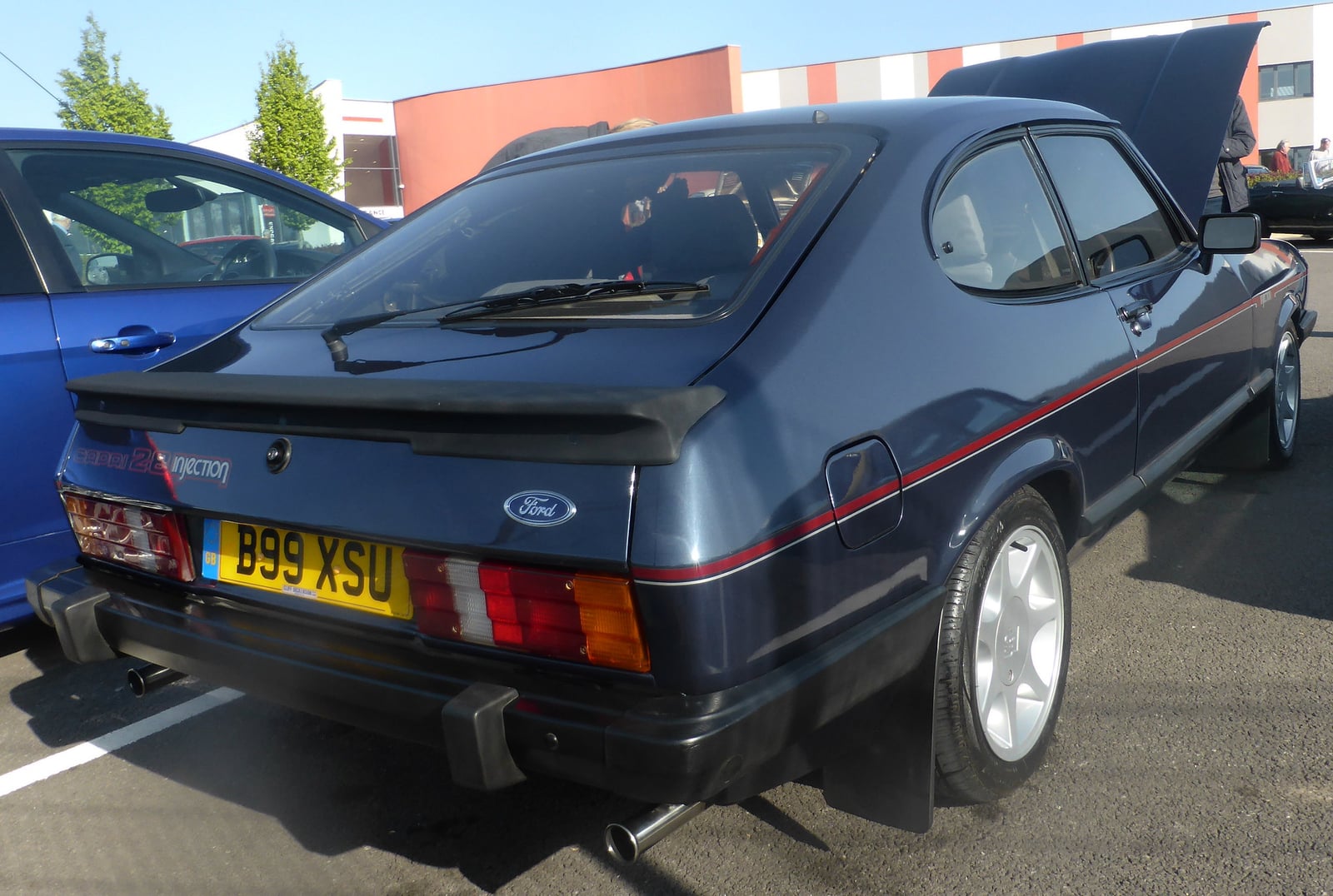 A dark Ford Capri 2.8 Injection, rear three-quarter view