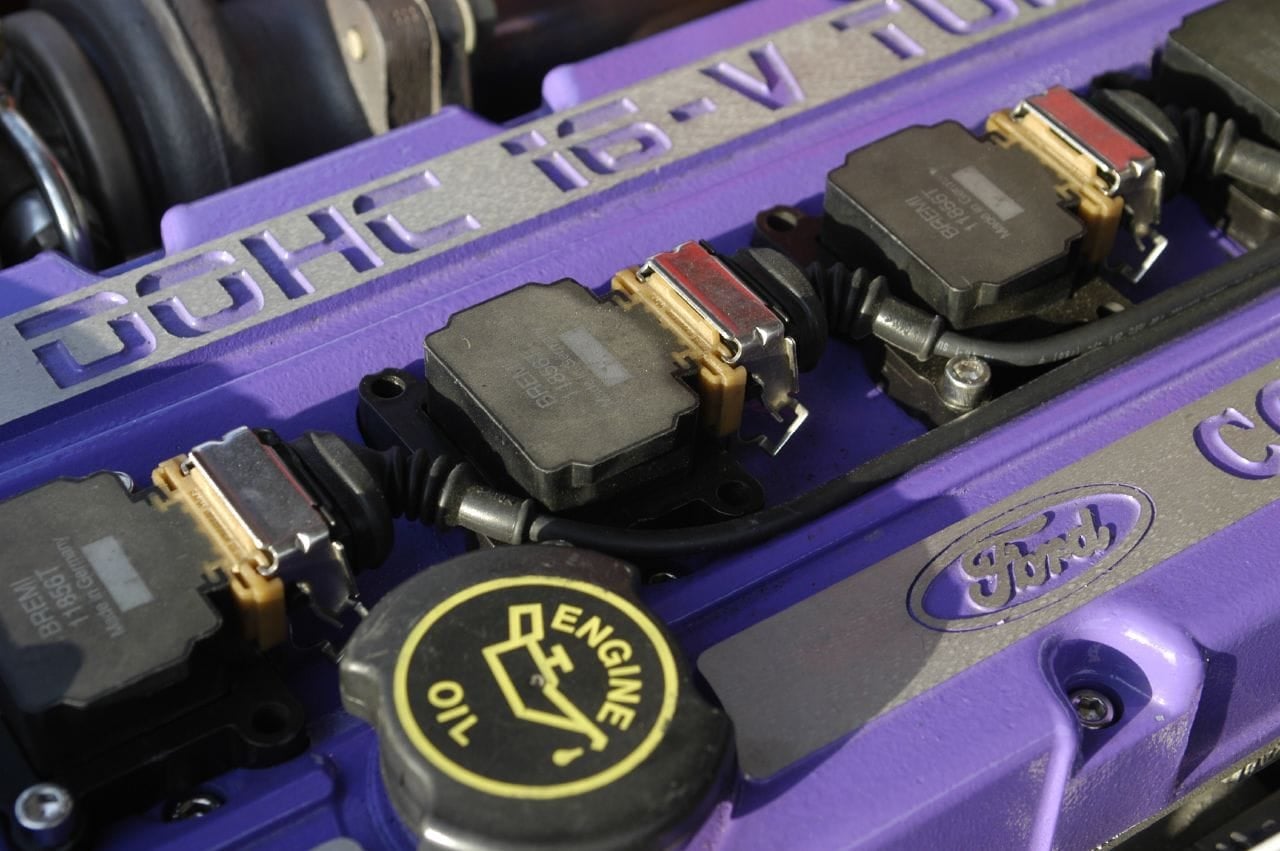 Close-up of a Ford Escort RS Cosworth cam cover reading DOHC 16V with the Ford oval and oil filler cap