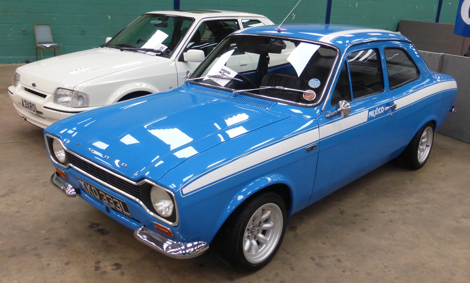 A blue Mk1 Ford Escort Mexico with a contrasting body stripe, front three-quarter view