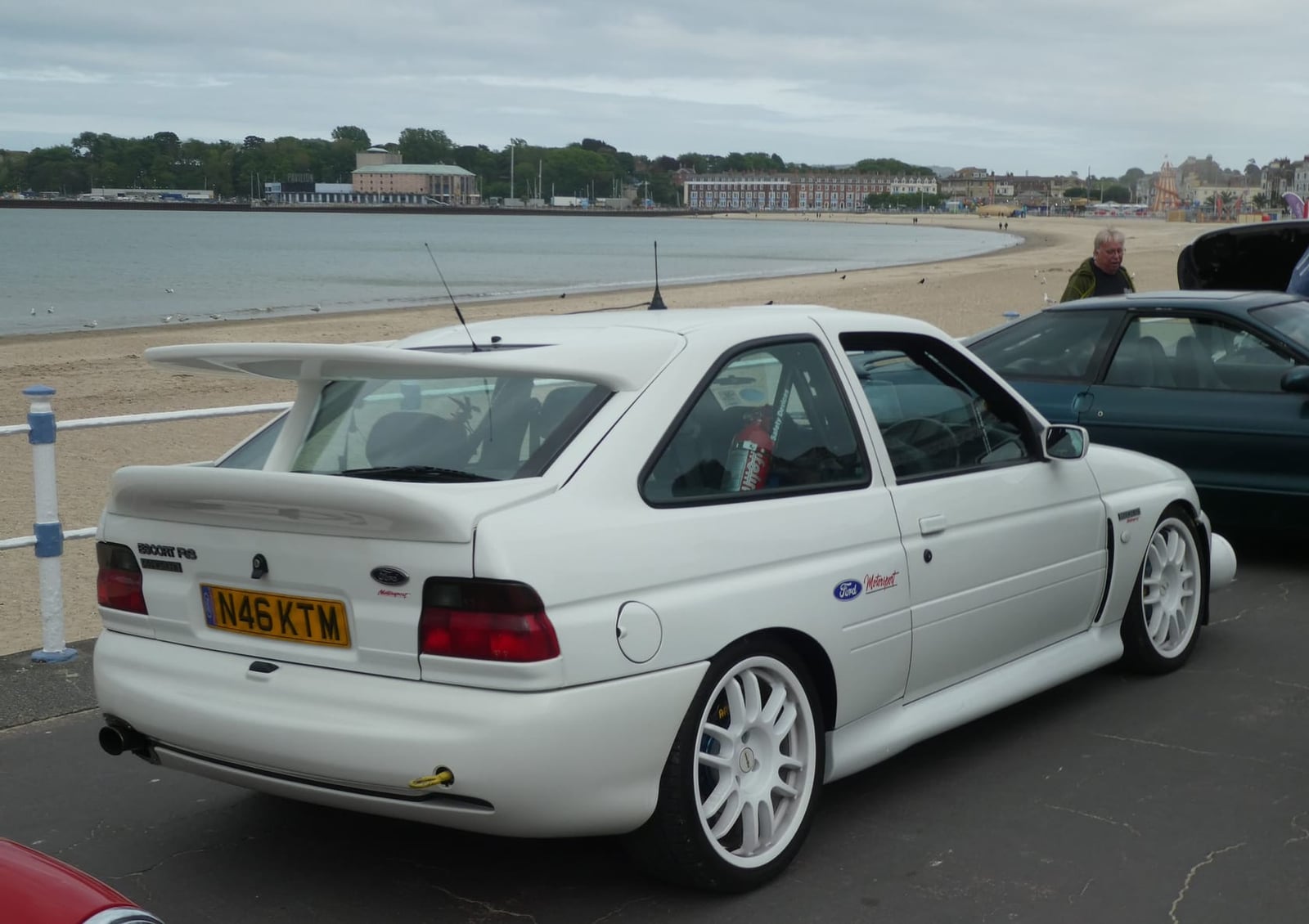 The rear of a white Ford Escort RS Cosworth showing the double whale-tail rear wing