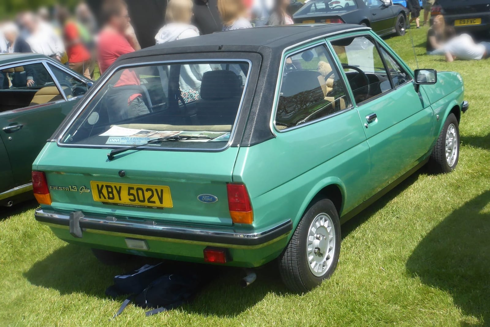The rear three-quarter of a green 1980 Ford Fiesta 1.3 Ghia with vinyl roof on grass