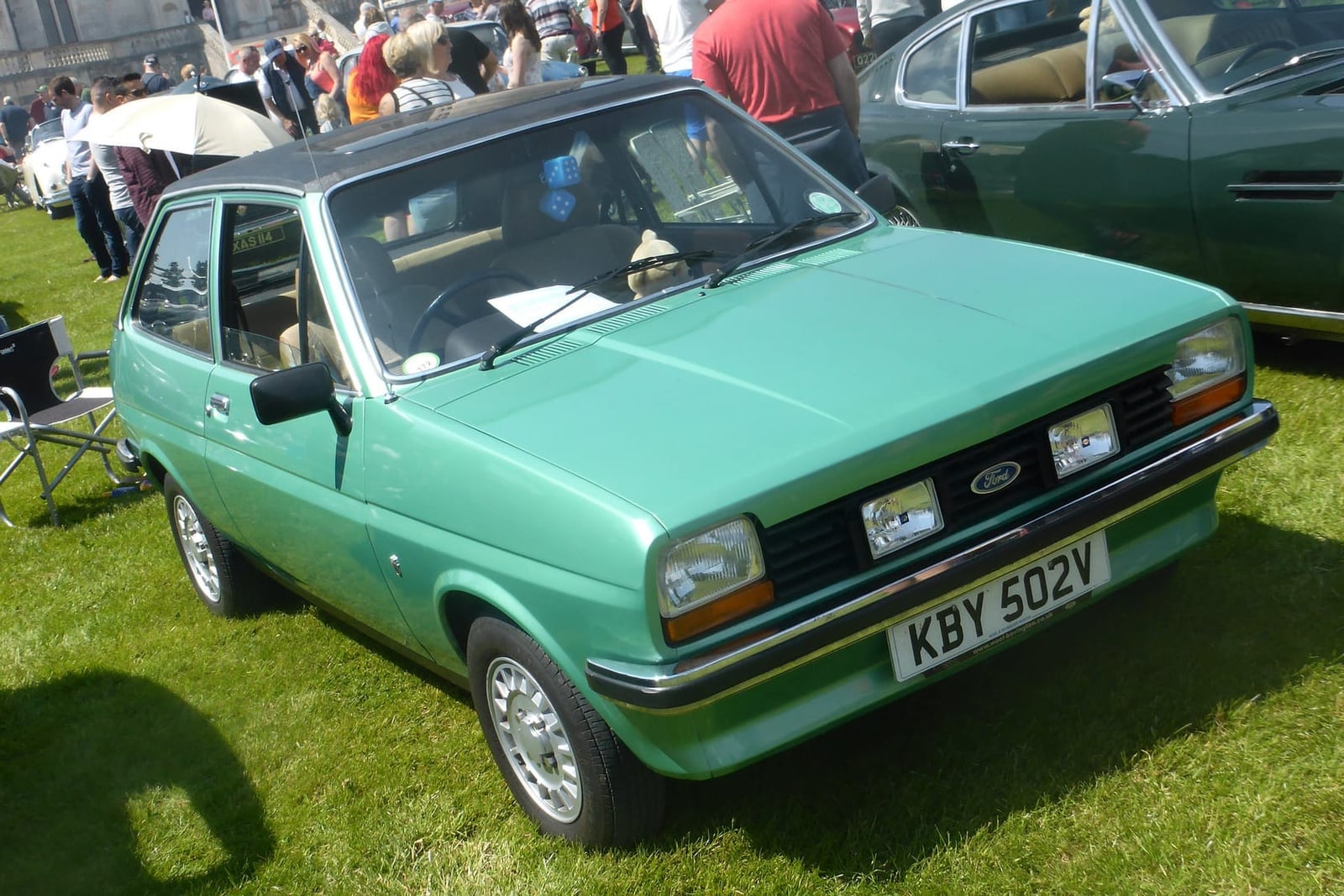 A green 1980 Ford Fiesta 1.3 Ghia with black vinyl roof on grass, front three-quarter view, UK registration KBY 502V