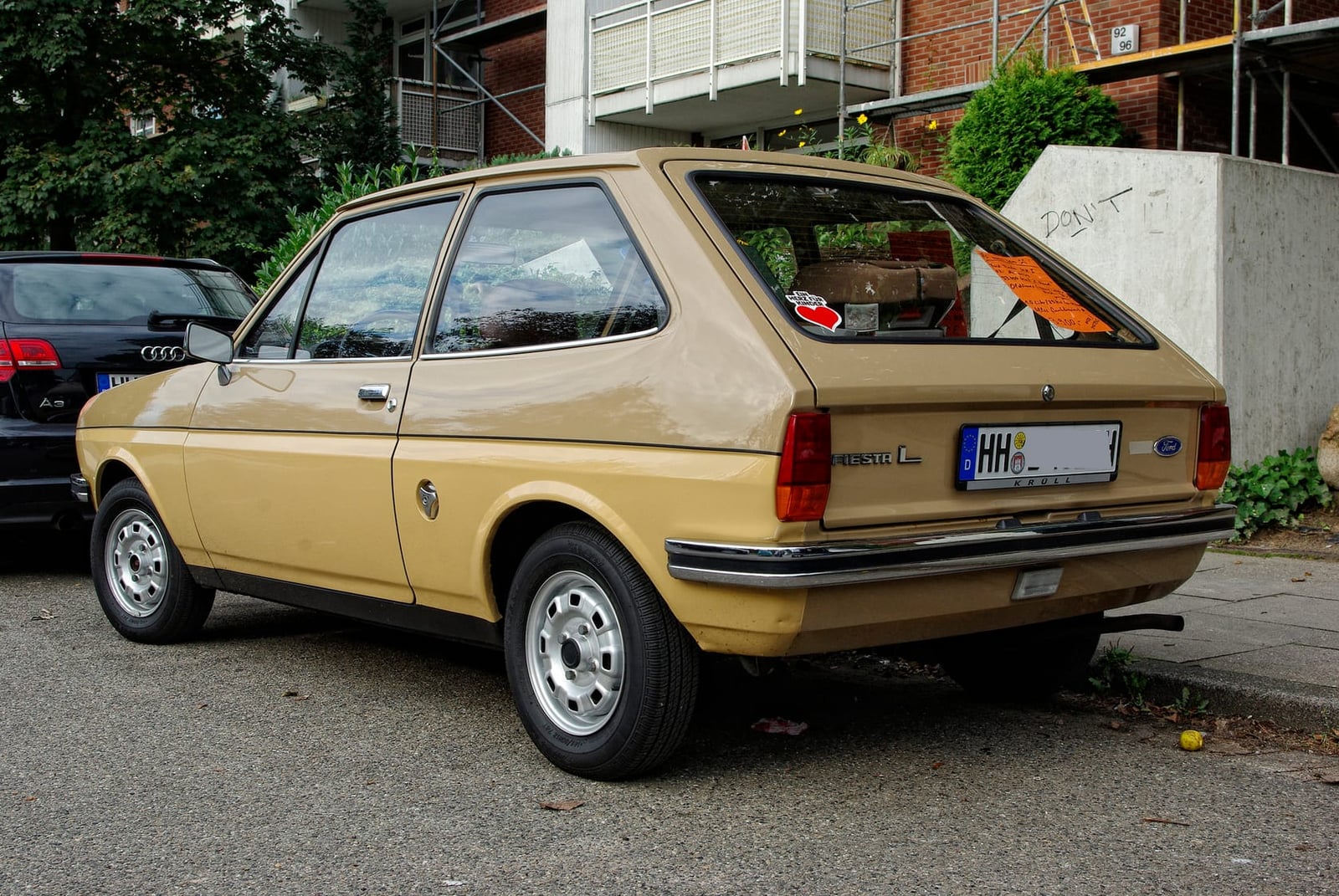 A beige Ford Fiesta L Mk1 parked on a street, rear three-quarter view