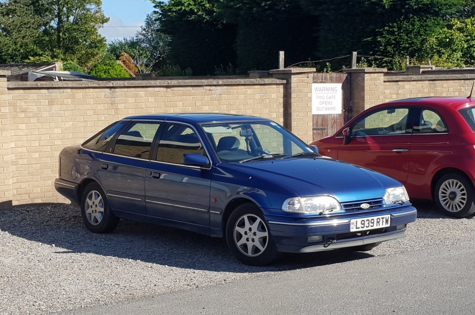 A blue Ford Granada Mk3 hatchback on a driveway, front three-quarter view