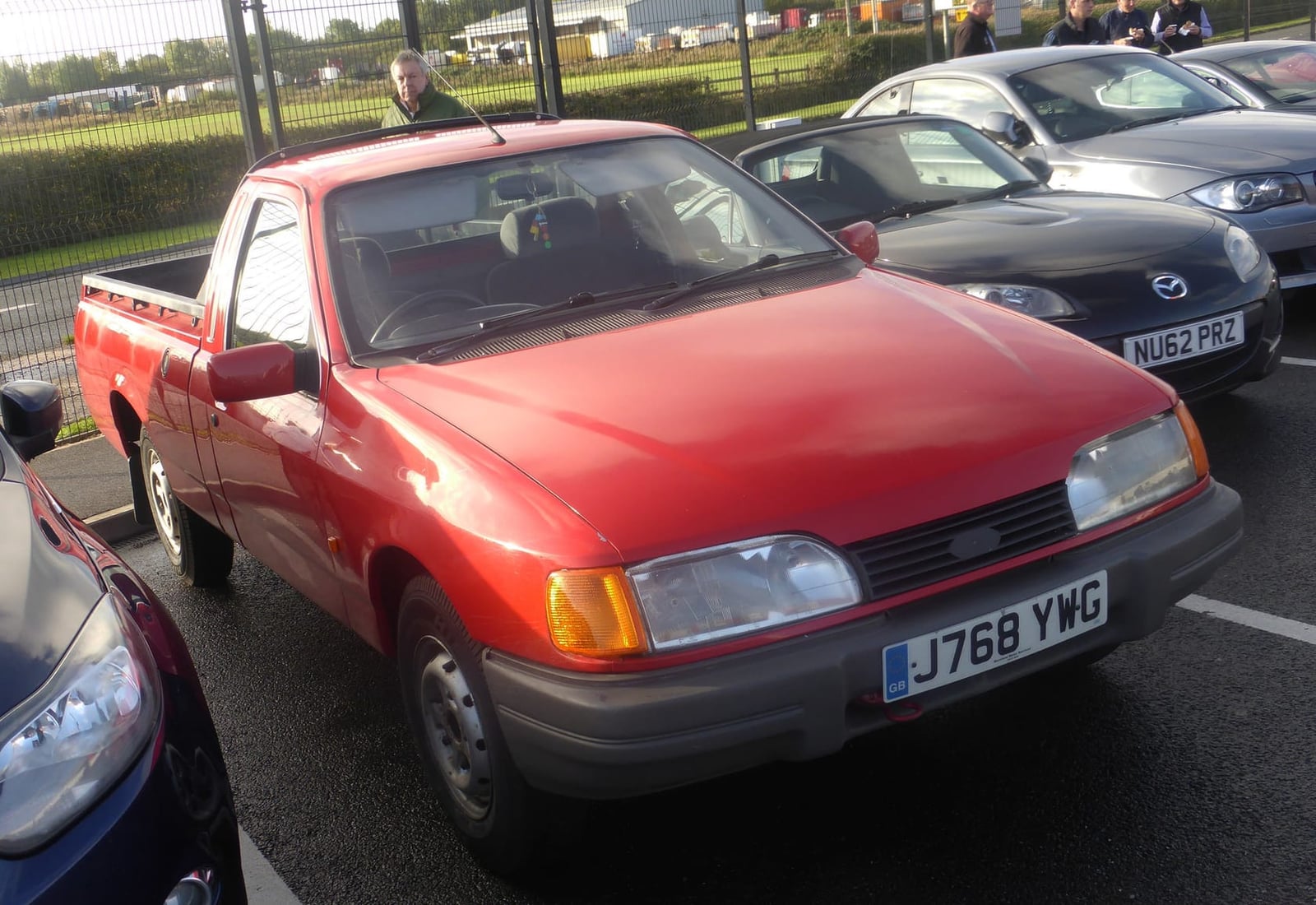 A red 1992 Ford P100 pickup based on the Sierra, front three-quarter view, UK registration J768 YWG