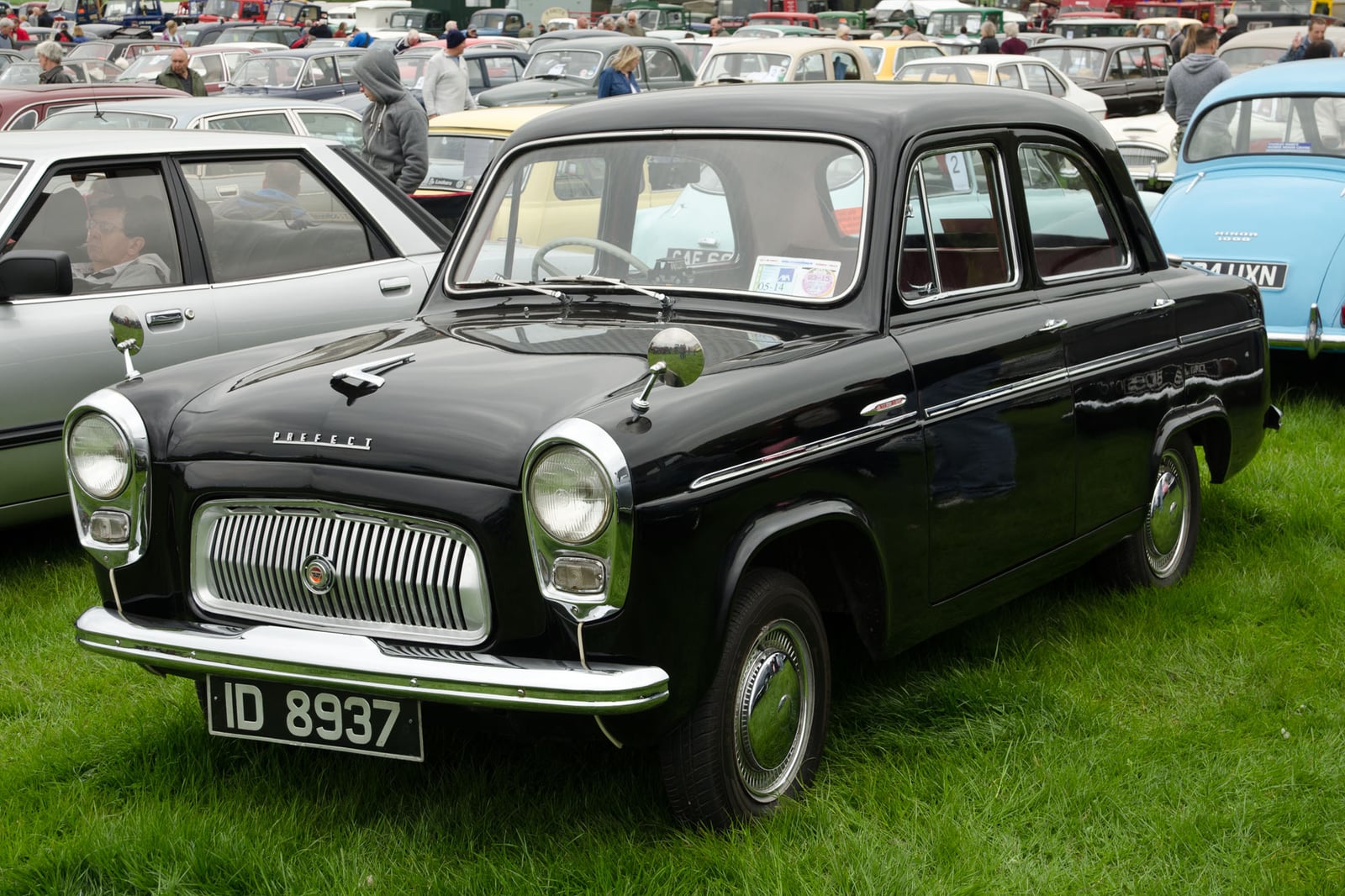 A two-tone grey Ford Prefect 100E saloon, front three-quarter view