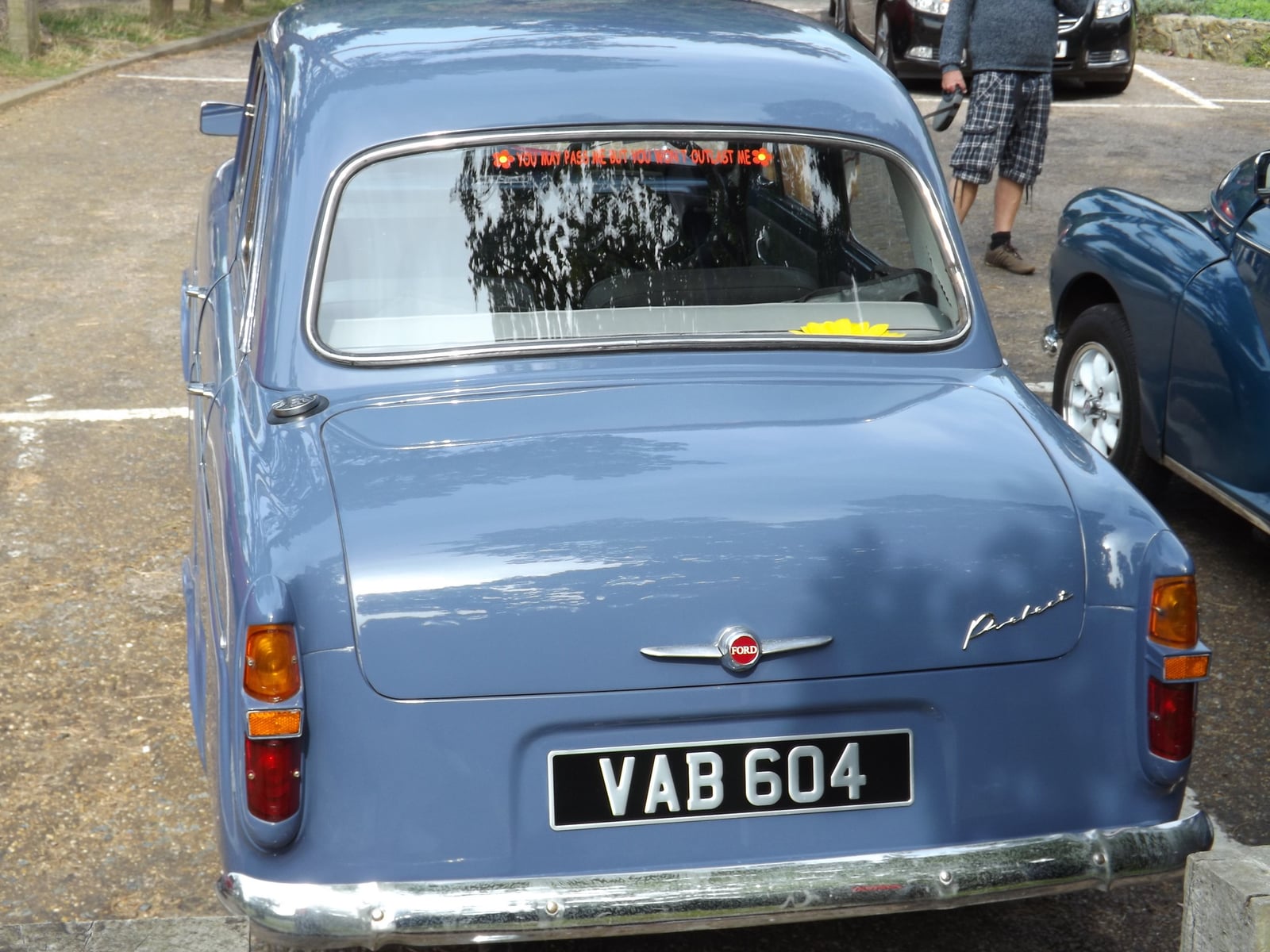 A blue Ford Prefect 100E saloon at a show, front three-quarter view