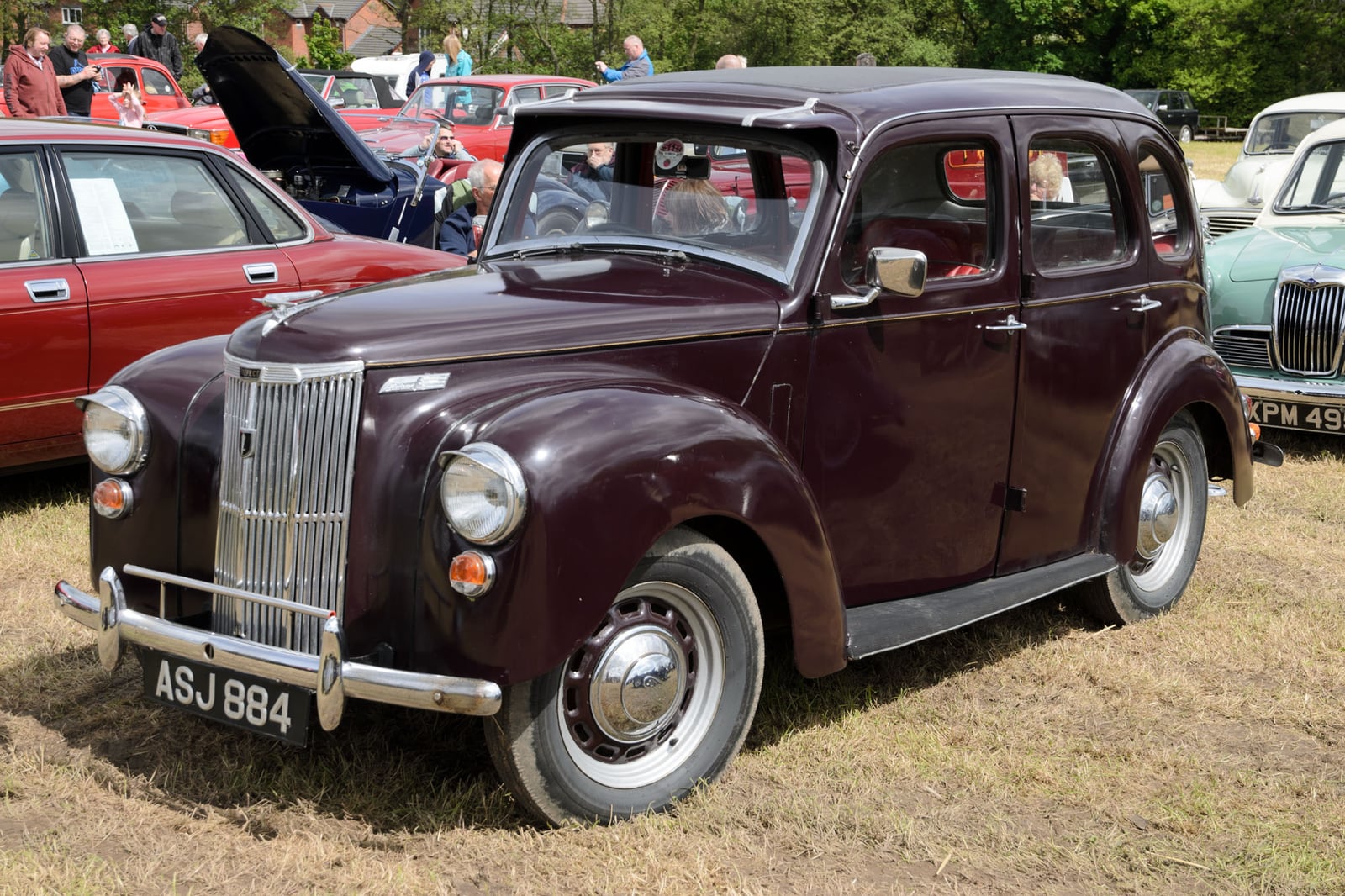 A grey upright Ford Prefect E493A saloon, front three-quarter view