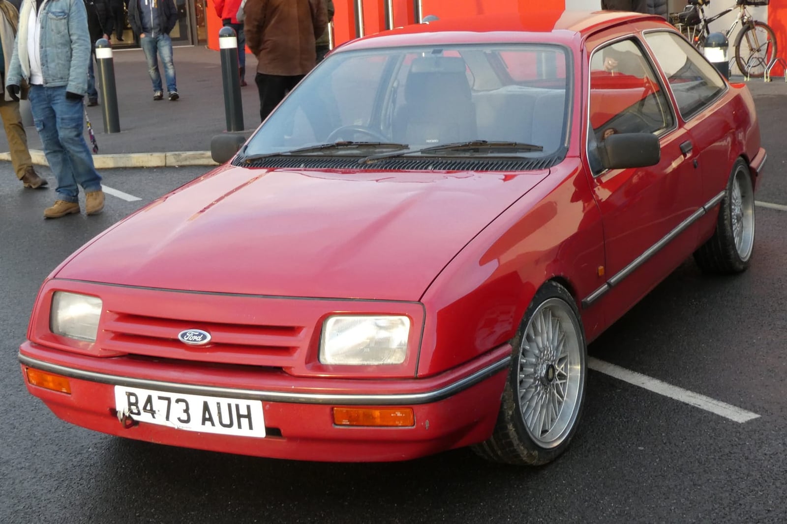 A red 1984 Ford Sierra 1.6 three-door on wire wheels, front three-quarter view, UK registration B473 AUH