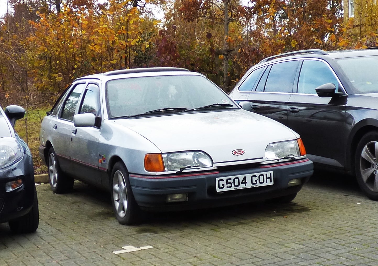 A silver Ford Sierra five-door hatchback, front three-quarter view in a car park