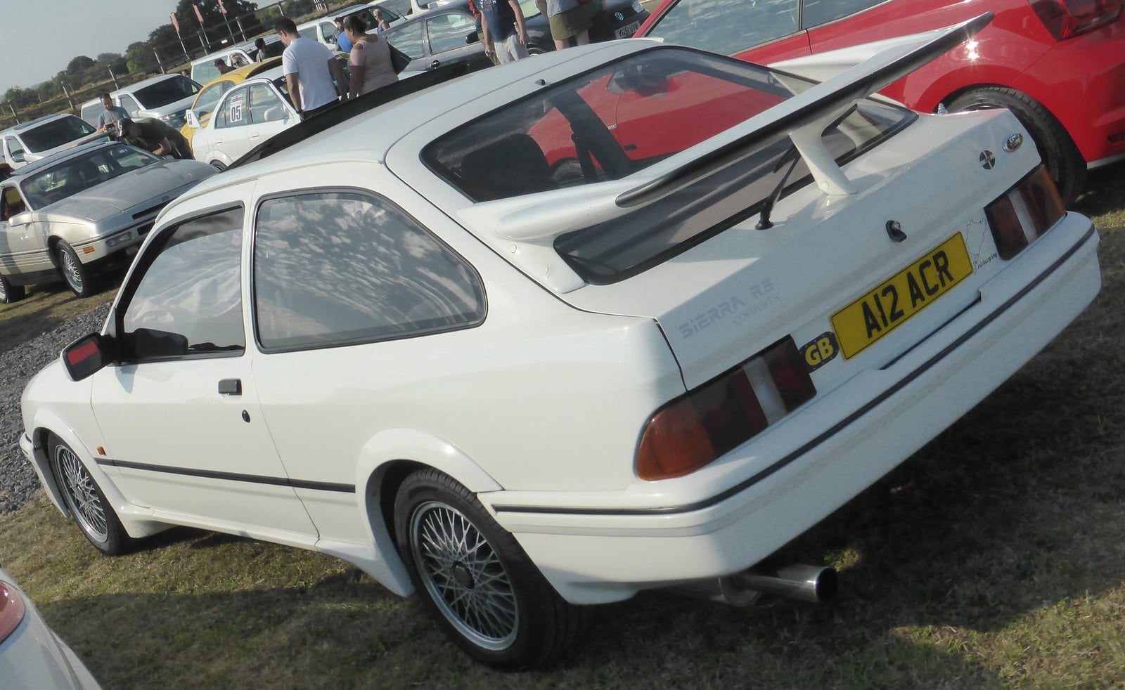 A grey three-door Ford Sierra RS Cosworth in profile, showing the whale-tail wing