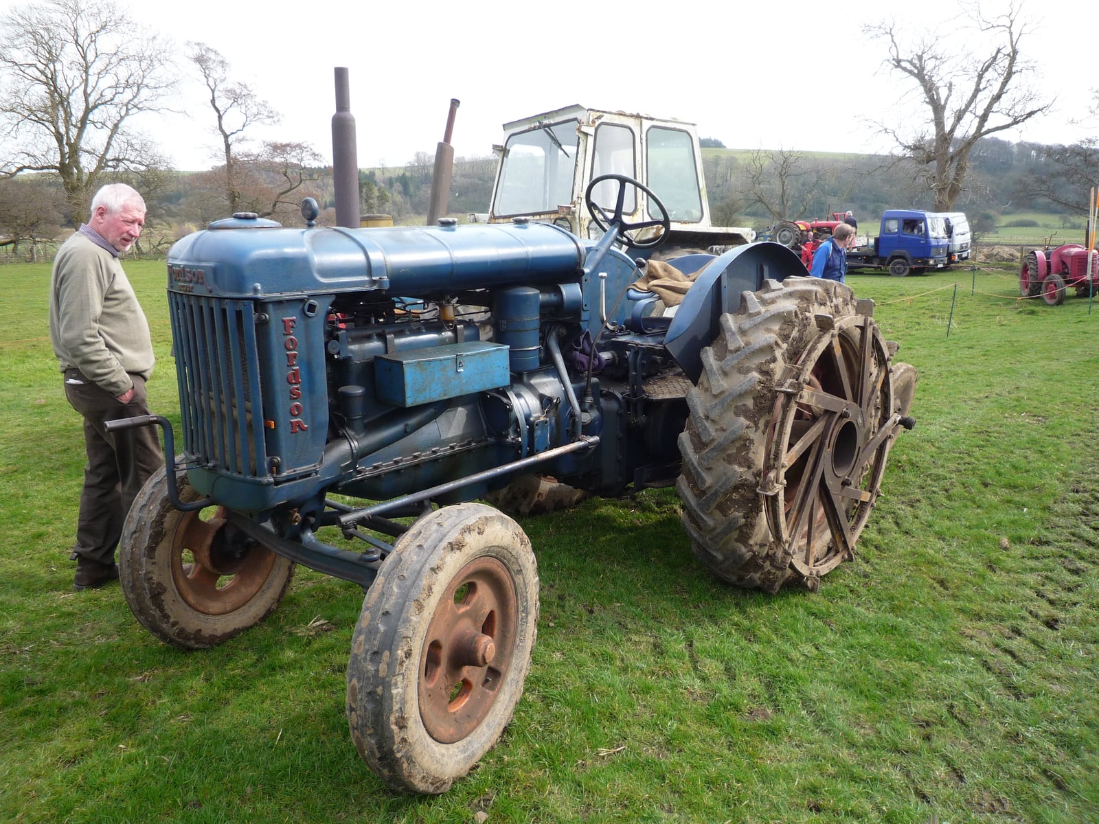 A blue Fordson Major E27N in a field at Bolton-by-Bowland, Yorkshire, its owner standing alongside