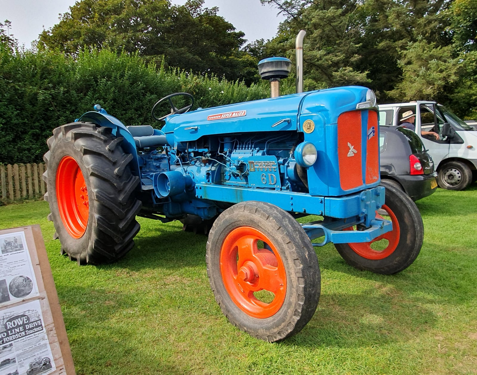 A blue and orange Fordson Super Major parked on grass at a Cornish vintage rally