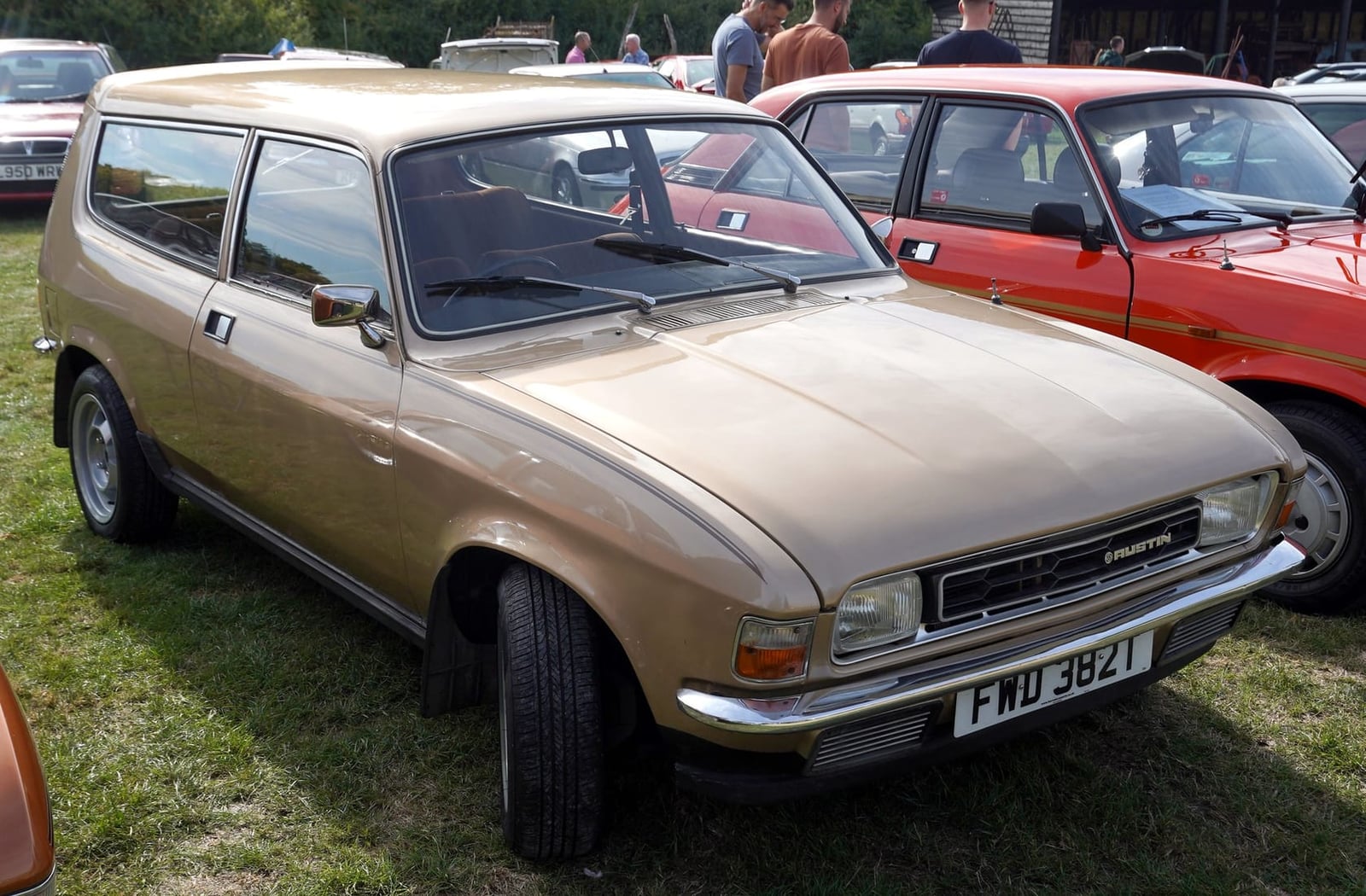 A gold Austin Allegro estate at a classic car show, front three-quarter view, UK registration FWD 382T