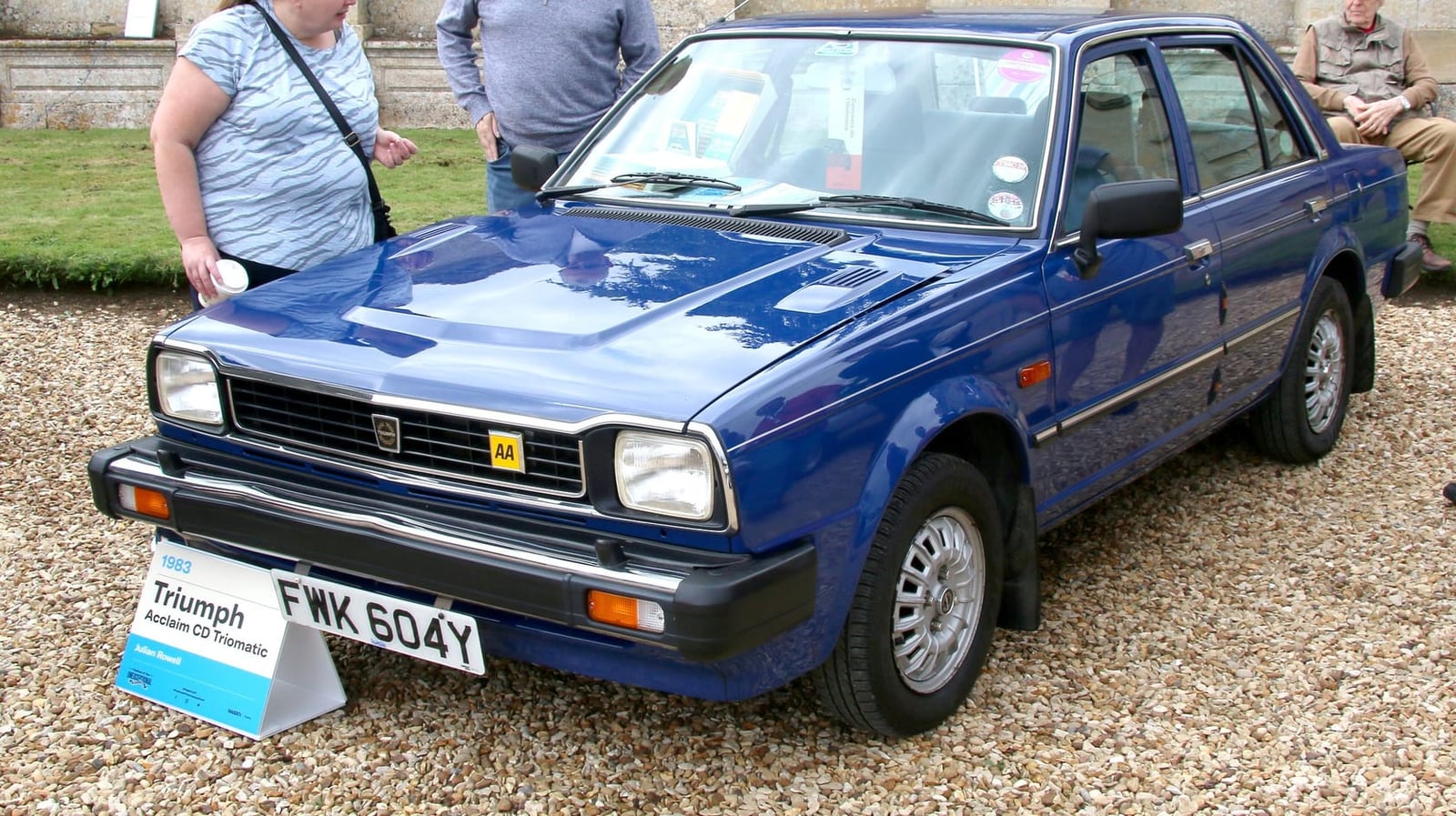 A blue 1983 Triumph Acclaim CD Triomatic on display at a classic car show, front three-quarter view, UK registration FWK 604Y