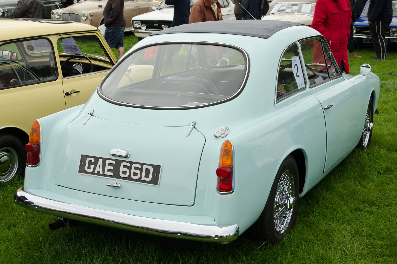 A pale blue Gilbern GT coupe, registration GAE 660, rear three-quarter view at a classic car show