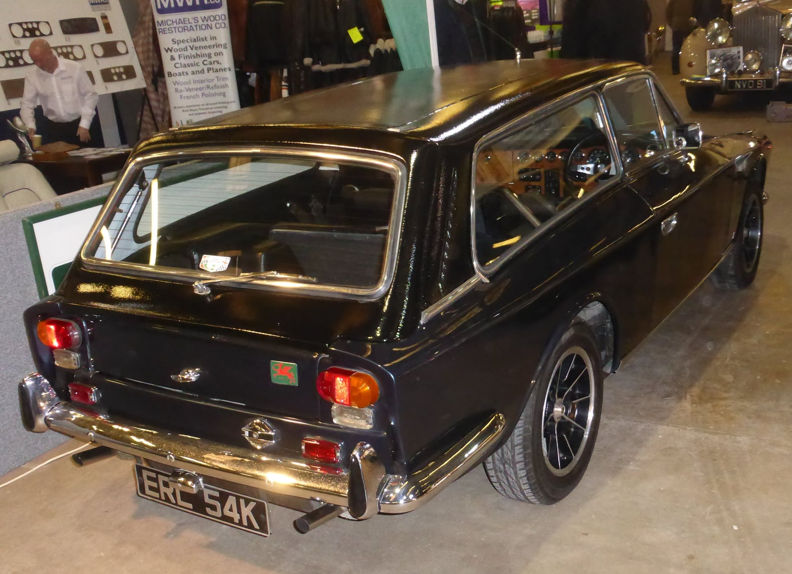 A brown Gilbern Invader estate, rear three-quarter view showing the tailgate, at a classic car show