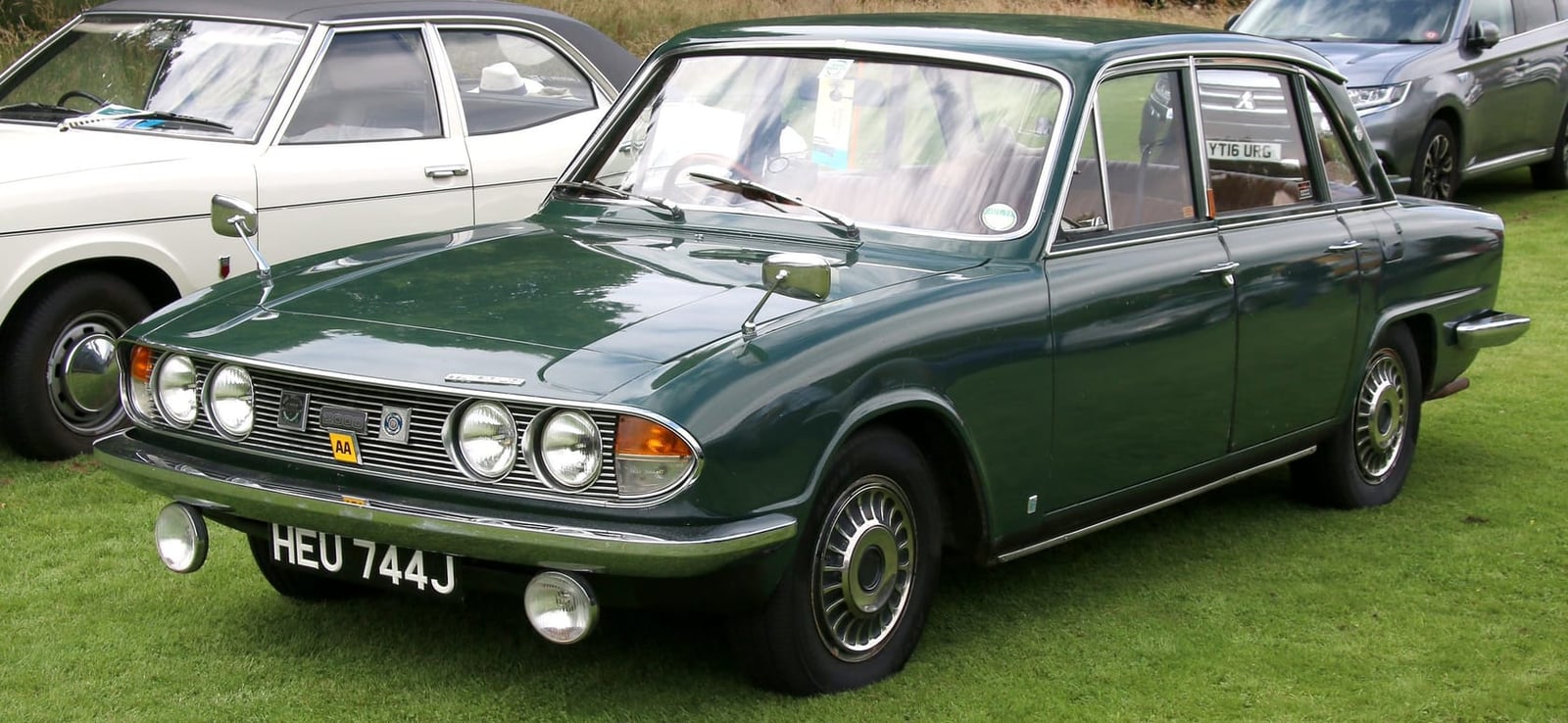 A dark green Triumph 2000 on grass at a classic car show, front three-quarter view, UK registration HEU 744J