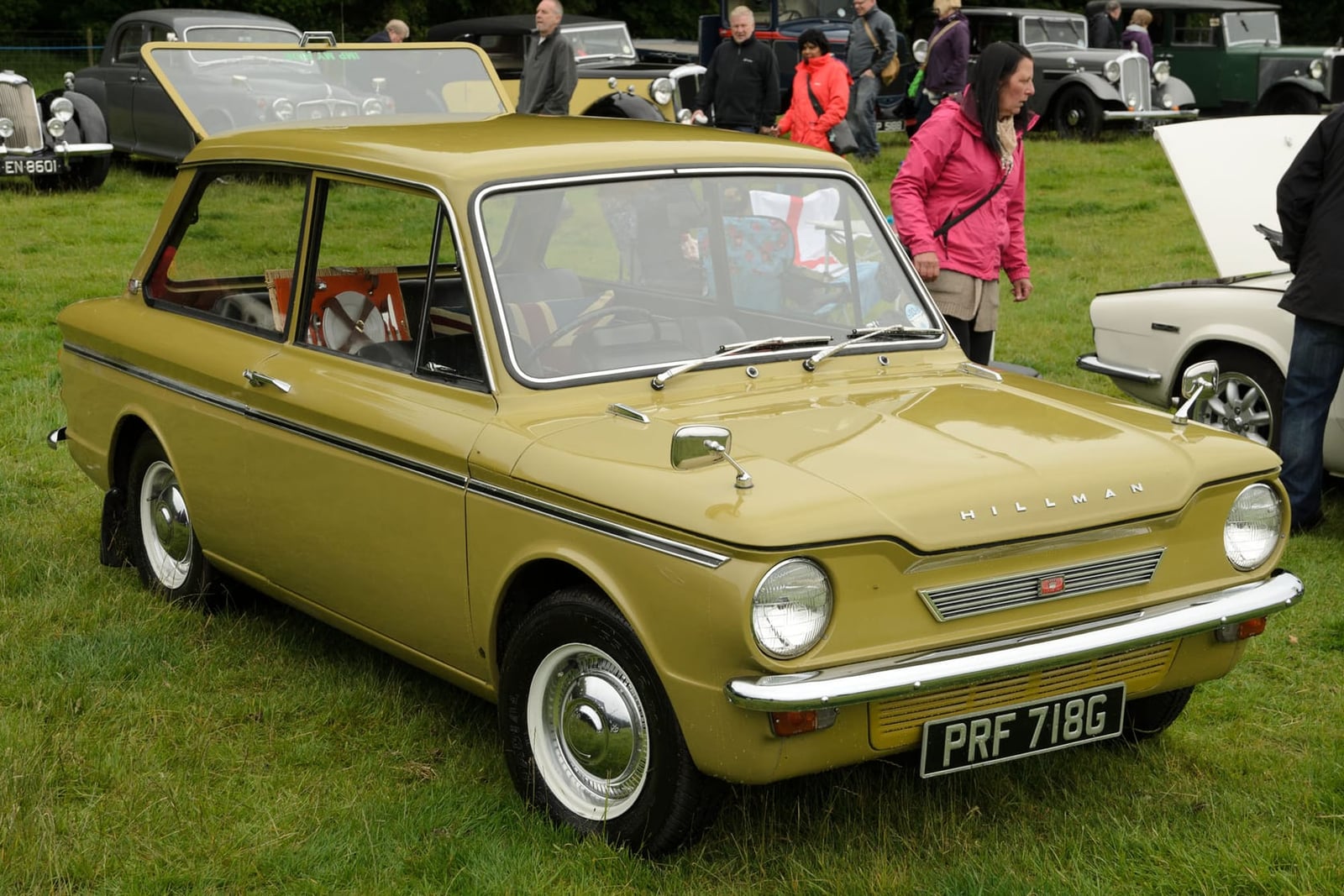 An olive-gold 1968 Hillman Imp at a show, front three-quarter view, UK registration PRF 718G