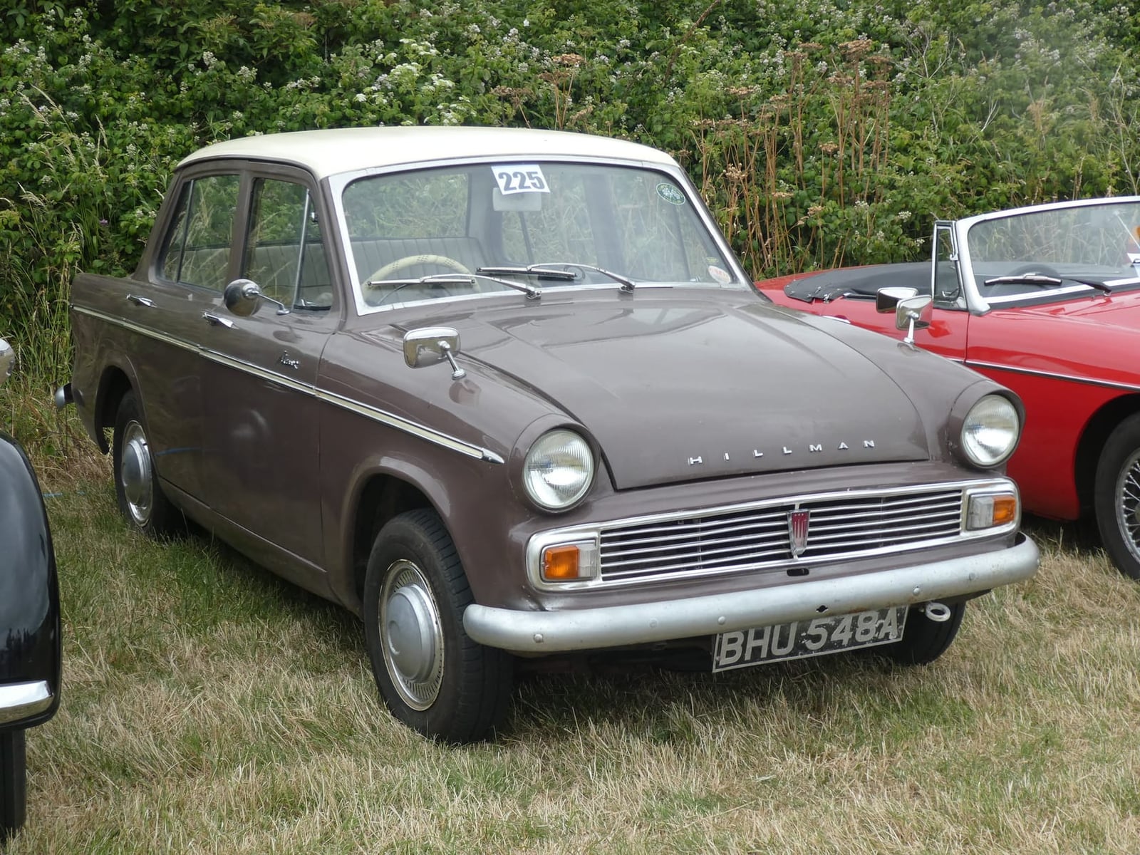 A brown and grey Hillman Minx Series V at a show, front three-quarter view, UK registration BHU 548A