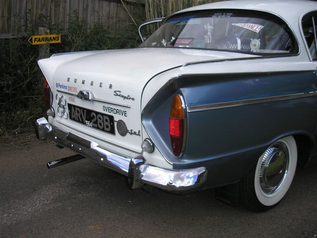 The rear of a blue and white Humber Sceptre showing the fins, tail lights and Overdrive badge, UK registration ARV 23B