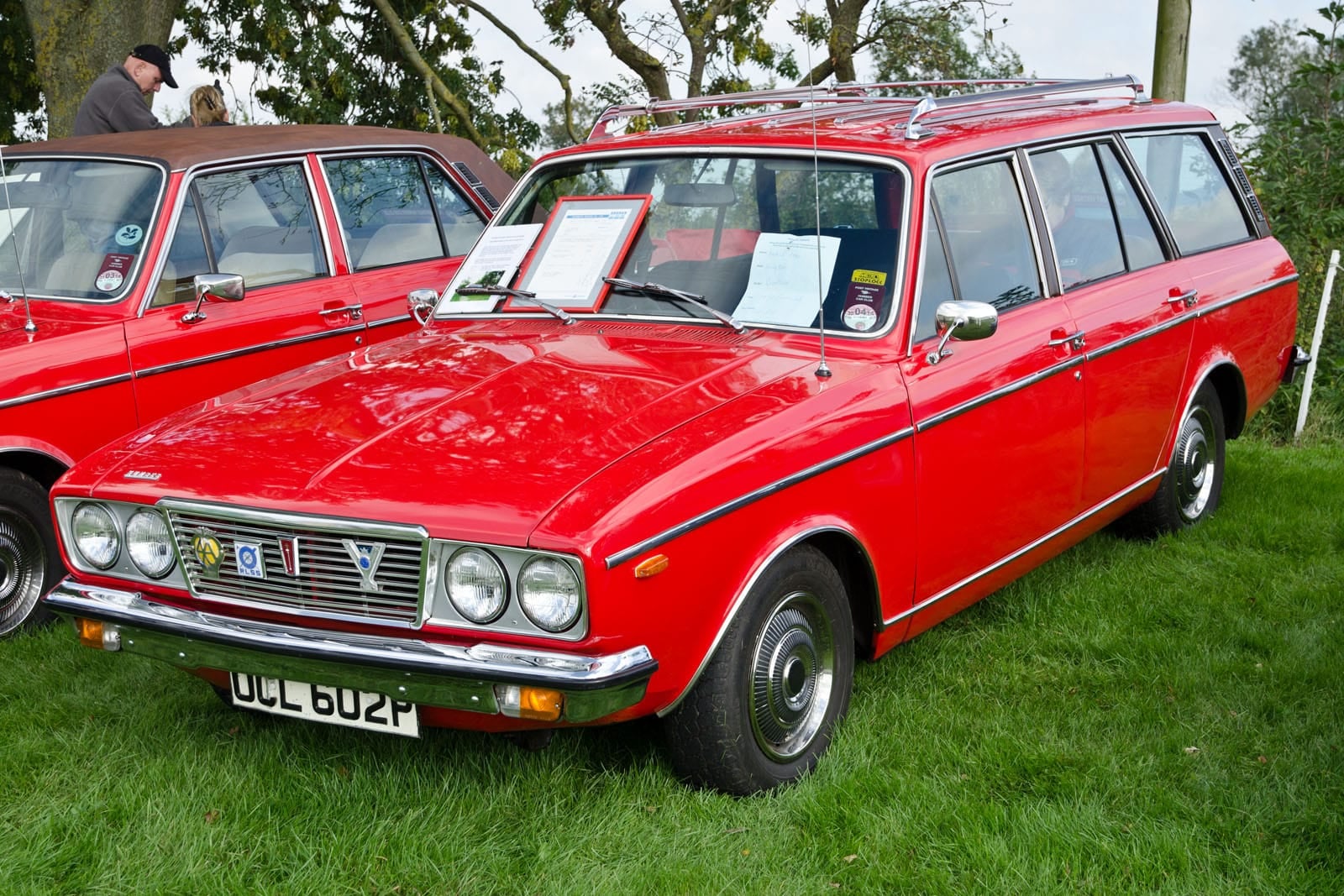 A red 1976 Humber Sceptre estate with roof rack at a show, front three-quarter view, UK registration OCL 602P