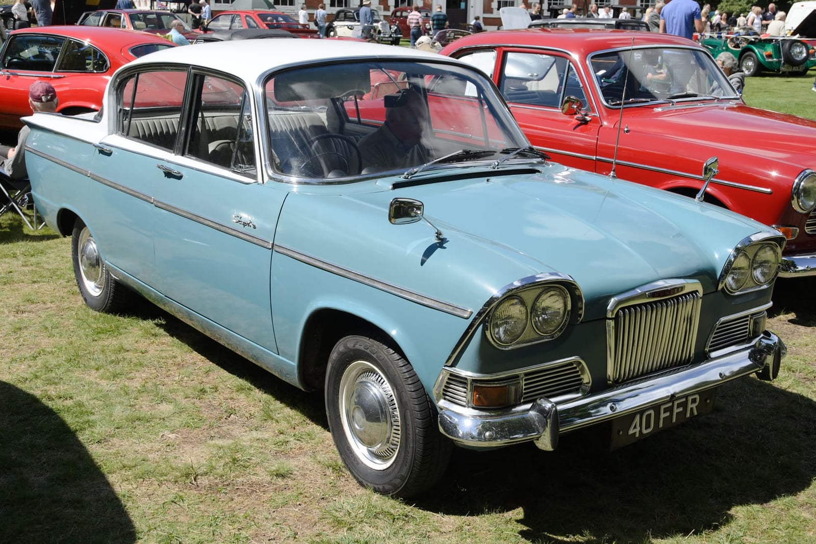 A dark red 1963 Humber Sceptre Mk I seen from the side and rear at a harbourside, UK registration CBK 721C