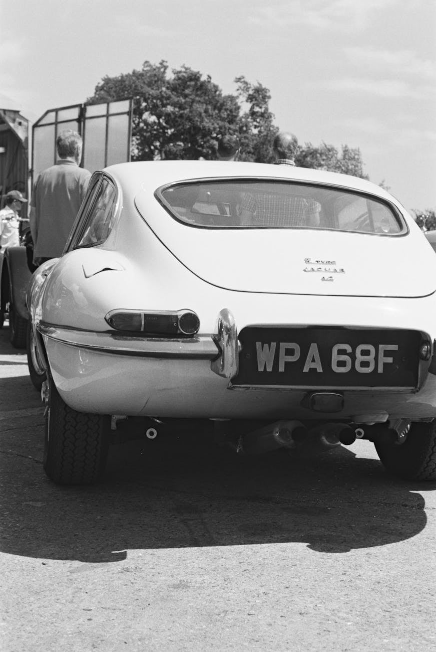 Rear of a white Jaguar E-Type 2+2 coupe showing the E-Type 4.2 bootlid badge