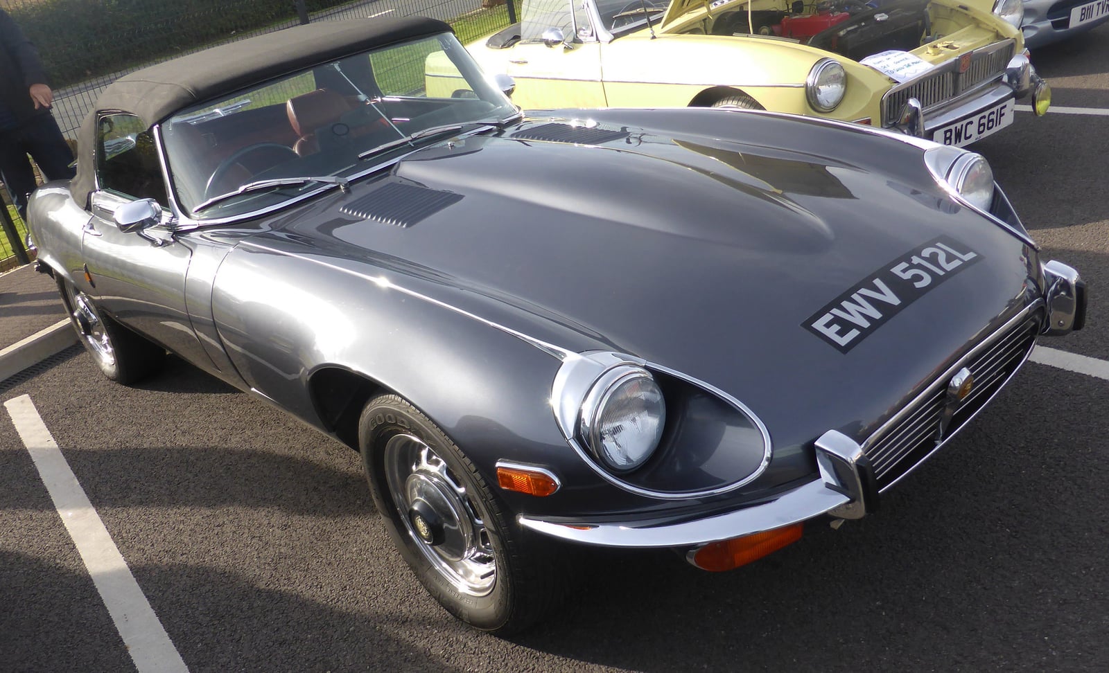 A silver Jaguar E-Type Series 3 V12 roadster, front three-quarter view