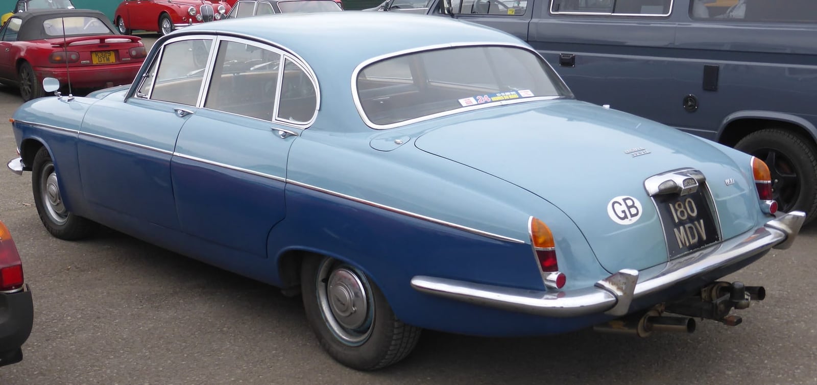 The rear three-quarter of a two-tone light blue 1962 Jaguar Mk X showing its tapering tail