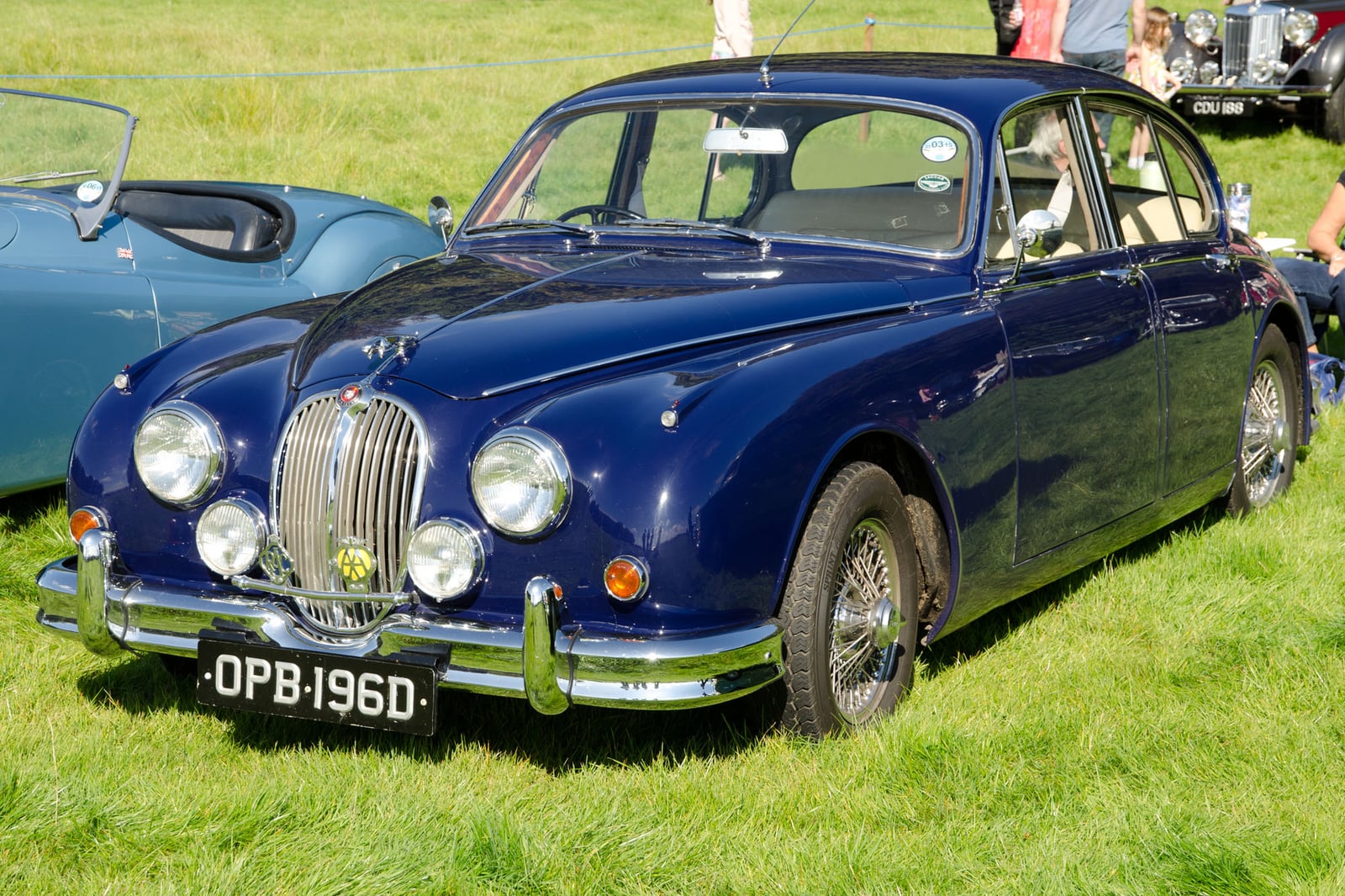 A blue Jaguar Mk2 2.4 saloon at a show, front three-quarter view