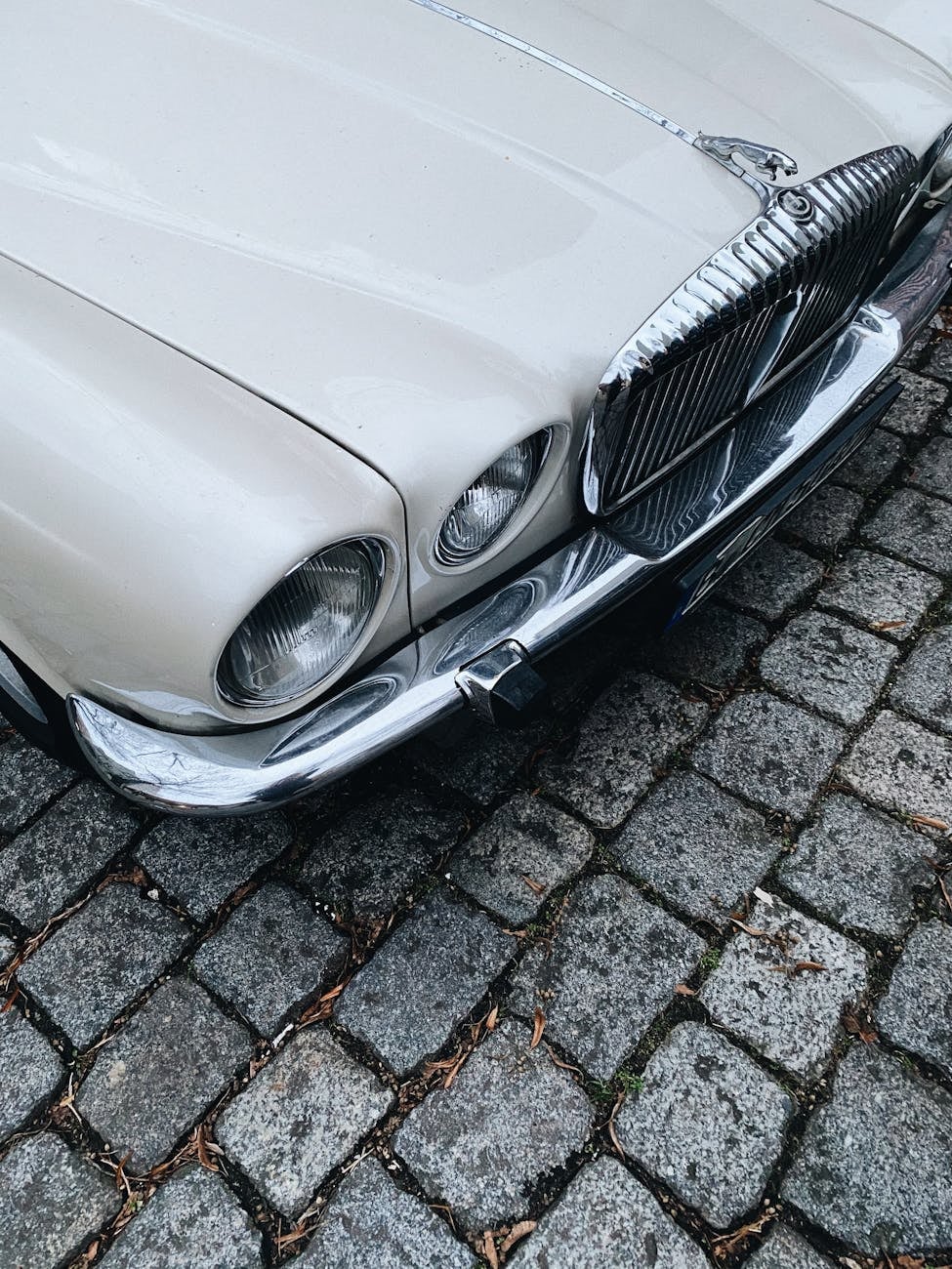 Close-up of a Jaguar XJ Series 1 front end showing the quad headlamps and slim chrome bumper