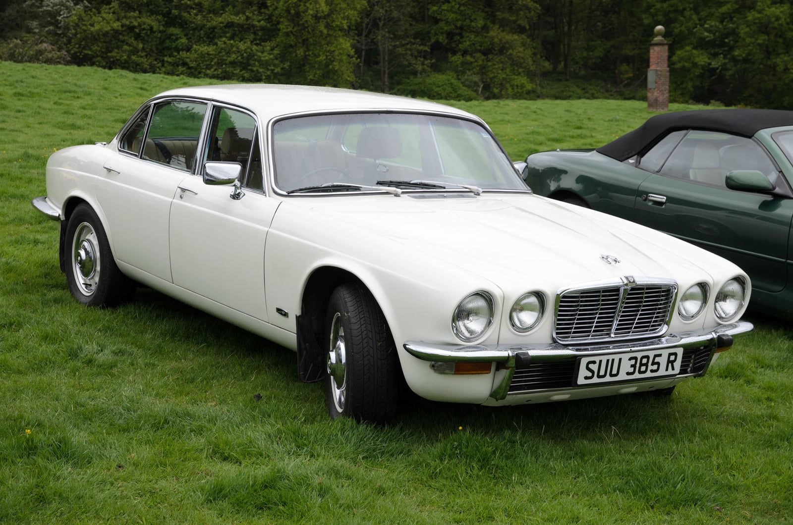 A white Jaguar XJ6 3.4 Series 2 saloon on grass, front three-quarter view