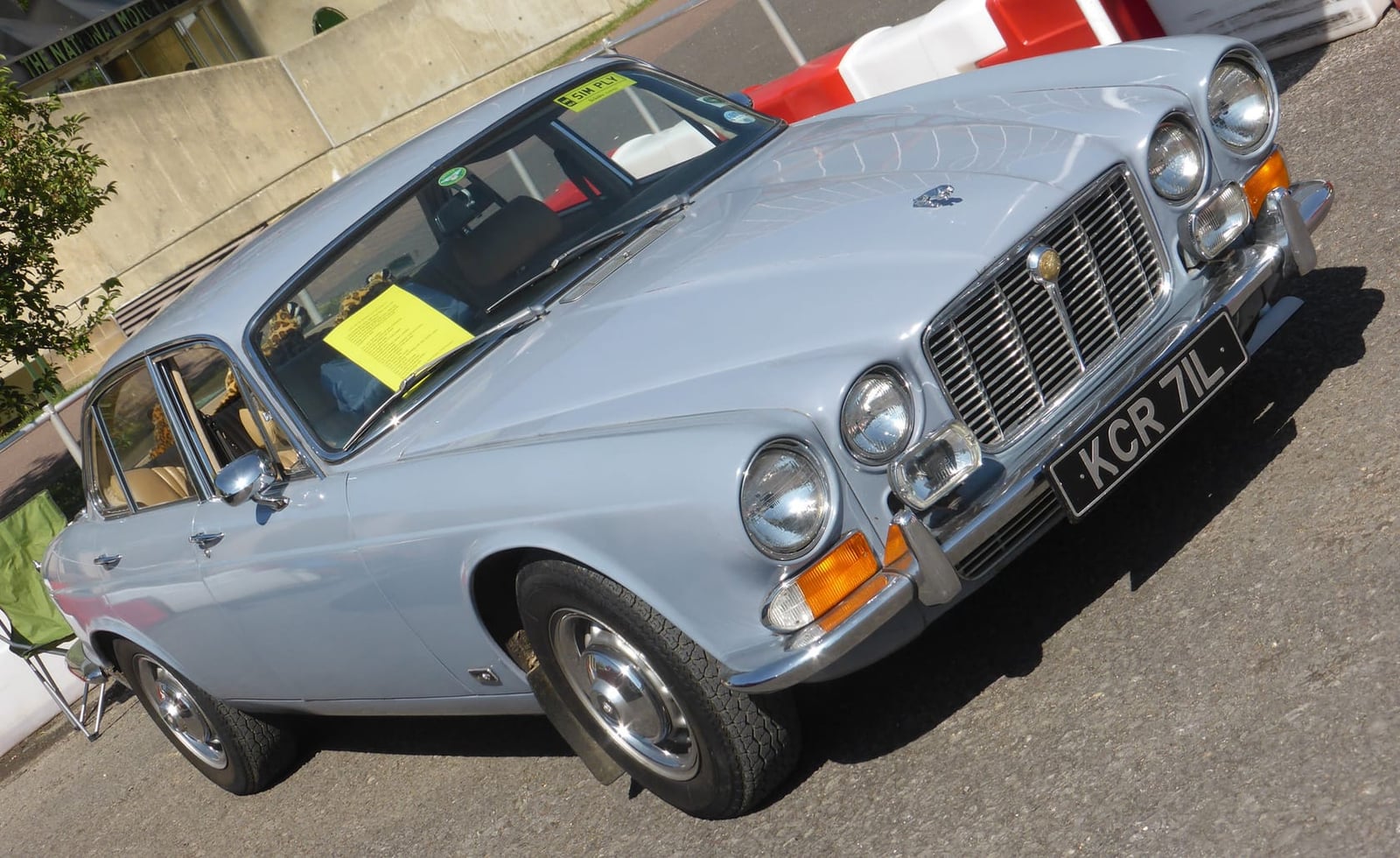 A silver-grey 1972 Jaguar XJ6 4.2 Series 1 with a UK registration at a show