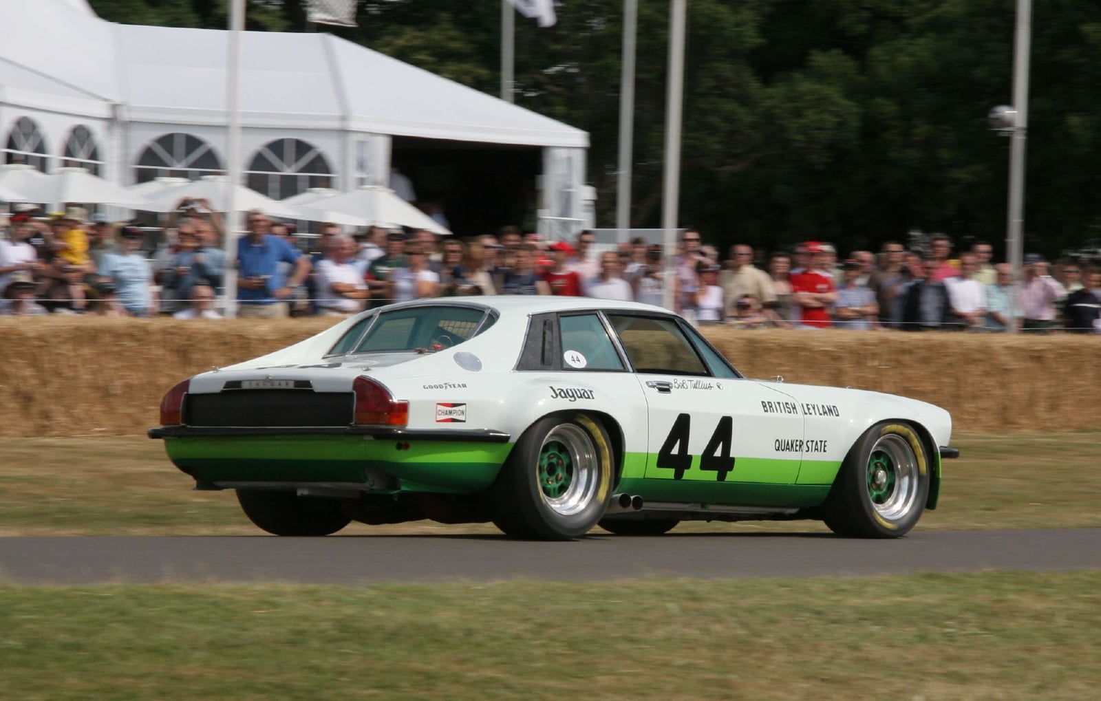 A white and green Jaguar XJS racing car, number 44, on a hill climb