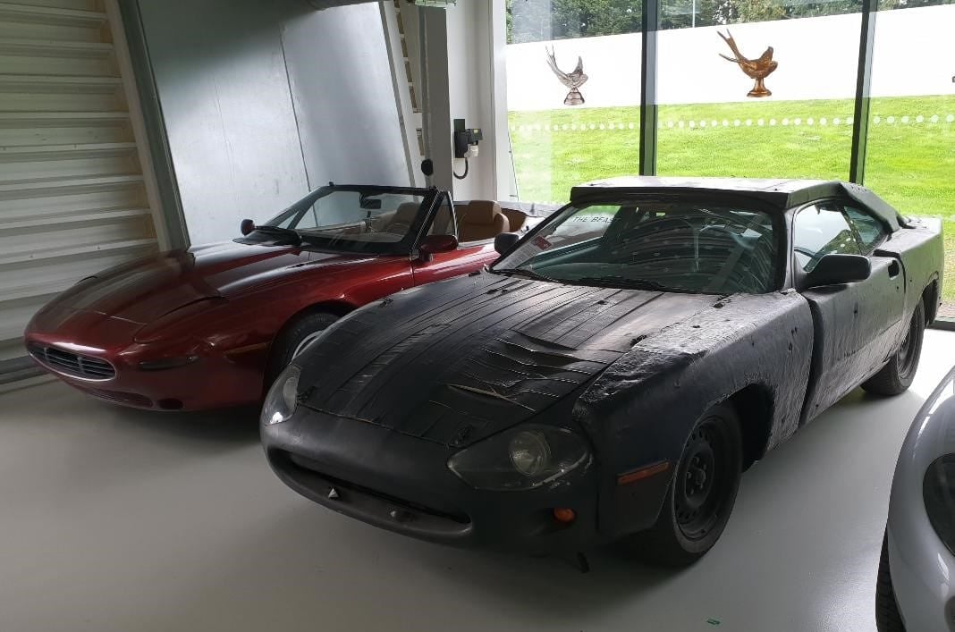 A disguised 1993 Jaguar XK8 development mule beside the XJ42 prototype in a museum