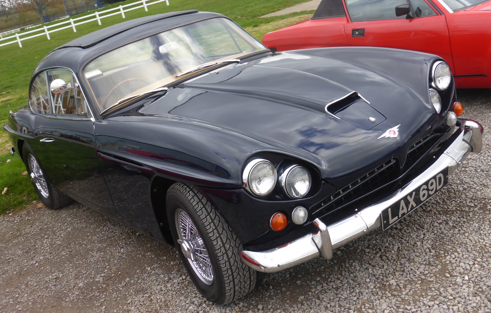 A dark Jensen CV8 Mk III at a show, front three-quarter view