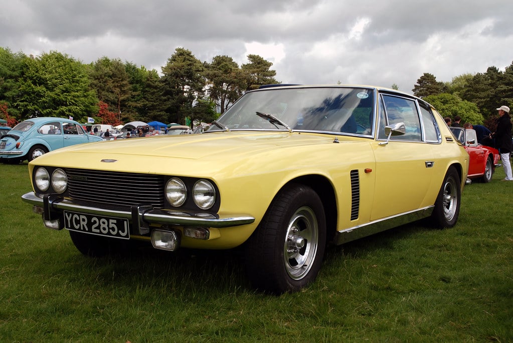 A yellow Jensen Interceptor at a show, front three-quarter view
